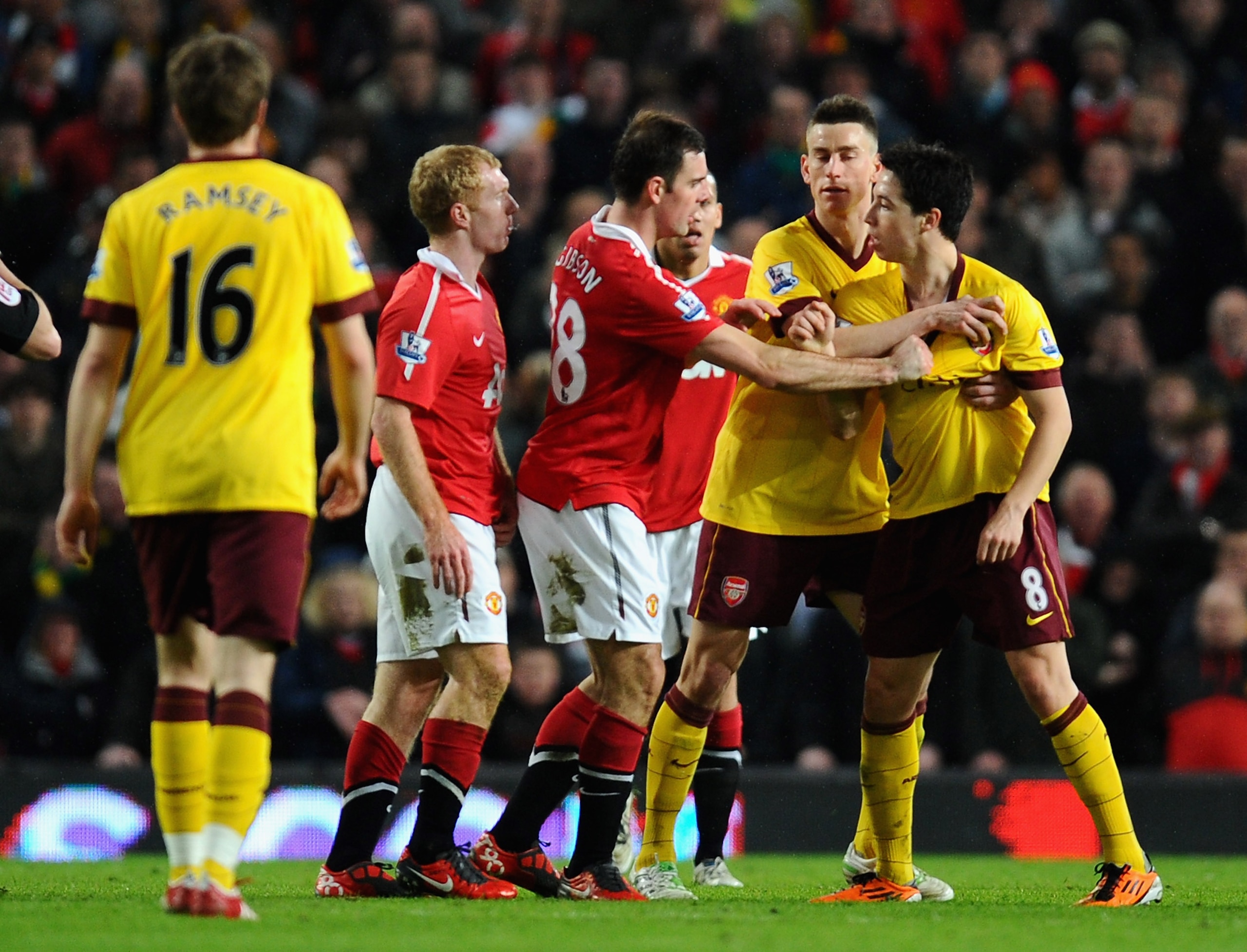 MANCHESTER, ENGLAND - MARCH 12:  Darron Gibson of Manchester United tries to separate team mate Paul Scholes from Samir Nasri of Arsenal as they argue during the FA Cup sponsored by E.On Sixth Round match between Manchester United and Arsenal at Old Traff