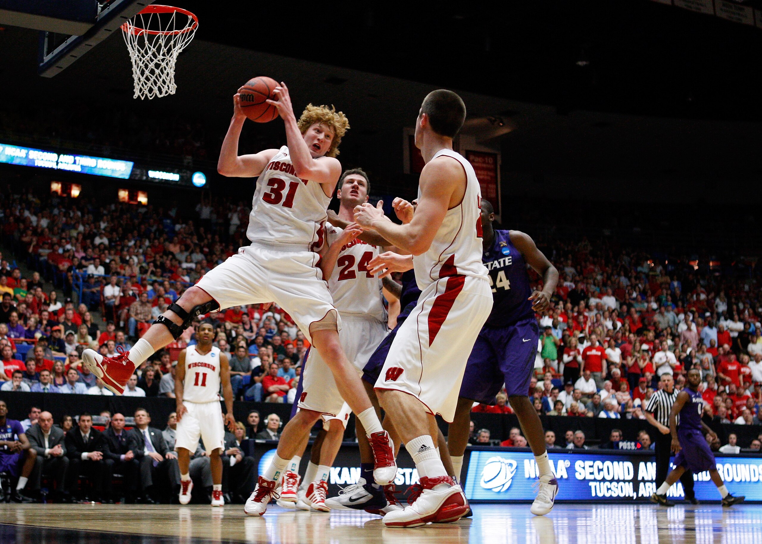 TUCSON, AZ - MARCH 19: Mike Bruesewitz #31 of the Wisconsin Badgers pulls down a rebound against the Kansas State Wildcats during the third round of the 2011 NCAA men's basketball tournament at McKale Center on March 19, 2011 in Tucson, Arizona. (Photo TUCSON, AZ - MARCH 19: Mike Bruesewitz #31 of the Wisconsin Badgers pulls down a rebound against the Kansas State Wildcats during the third round of the 2011 NCAA men's basketball tournament at McKale Center on March 19, 2011 in Tucson, Arizona. (Photo