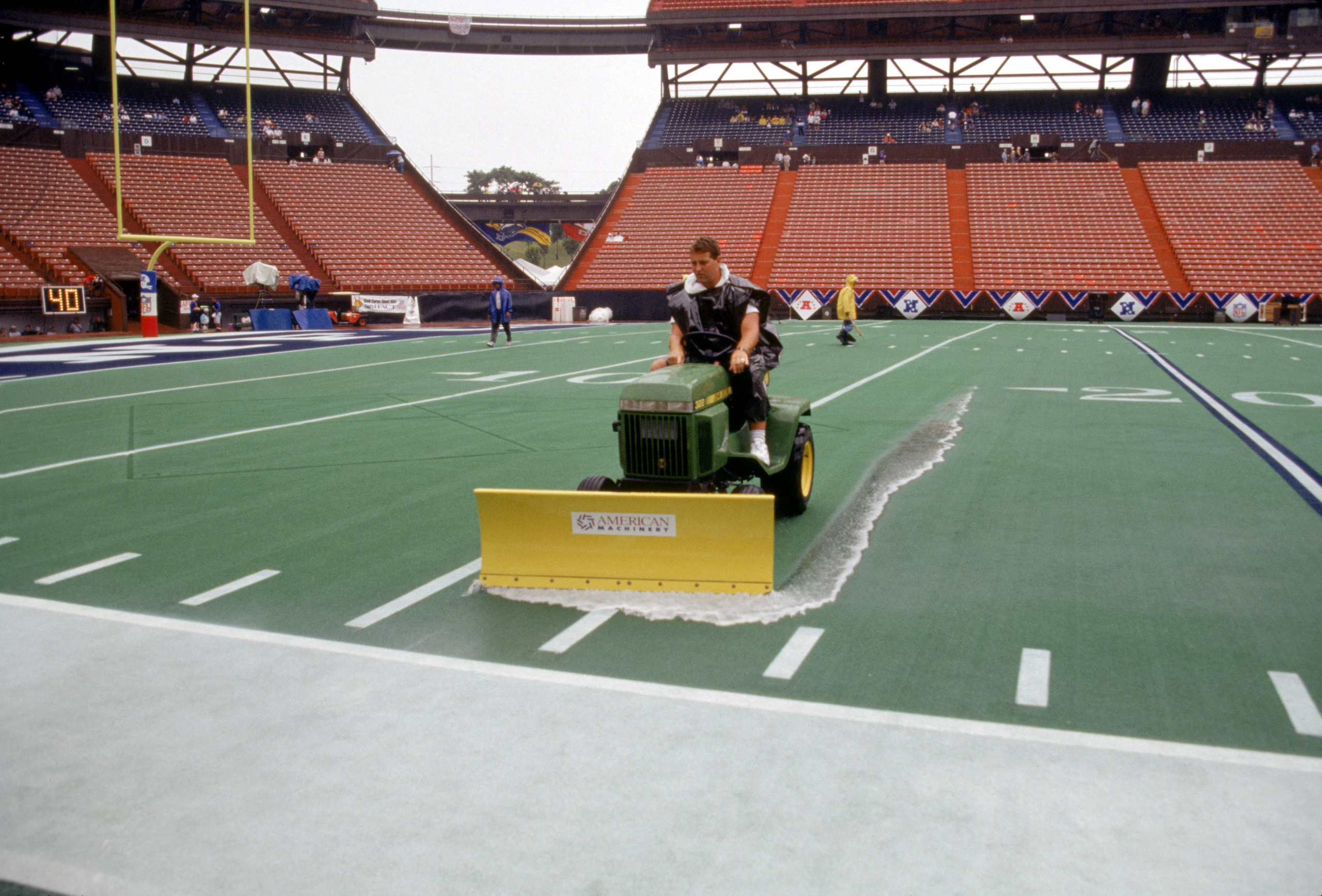 HONOLULU, HI - FEBRUARY 5:  Stadium grounds crew prepare the field as they remove rain water from the artificial turf prior to the 1995 NFL Pro Bowl at Aloha Stadium on February 5, 1995 in Honolulu, Hawaii.  The AFC defeated the NFC 41-13.  (Photo by Geor