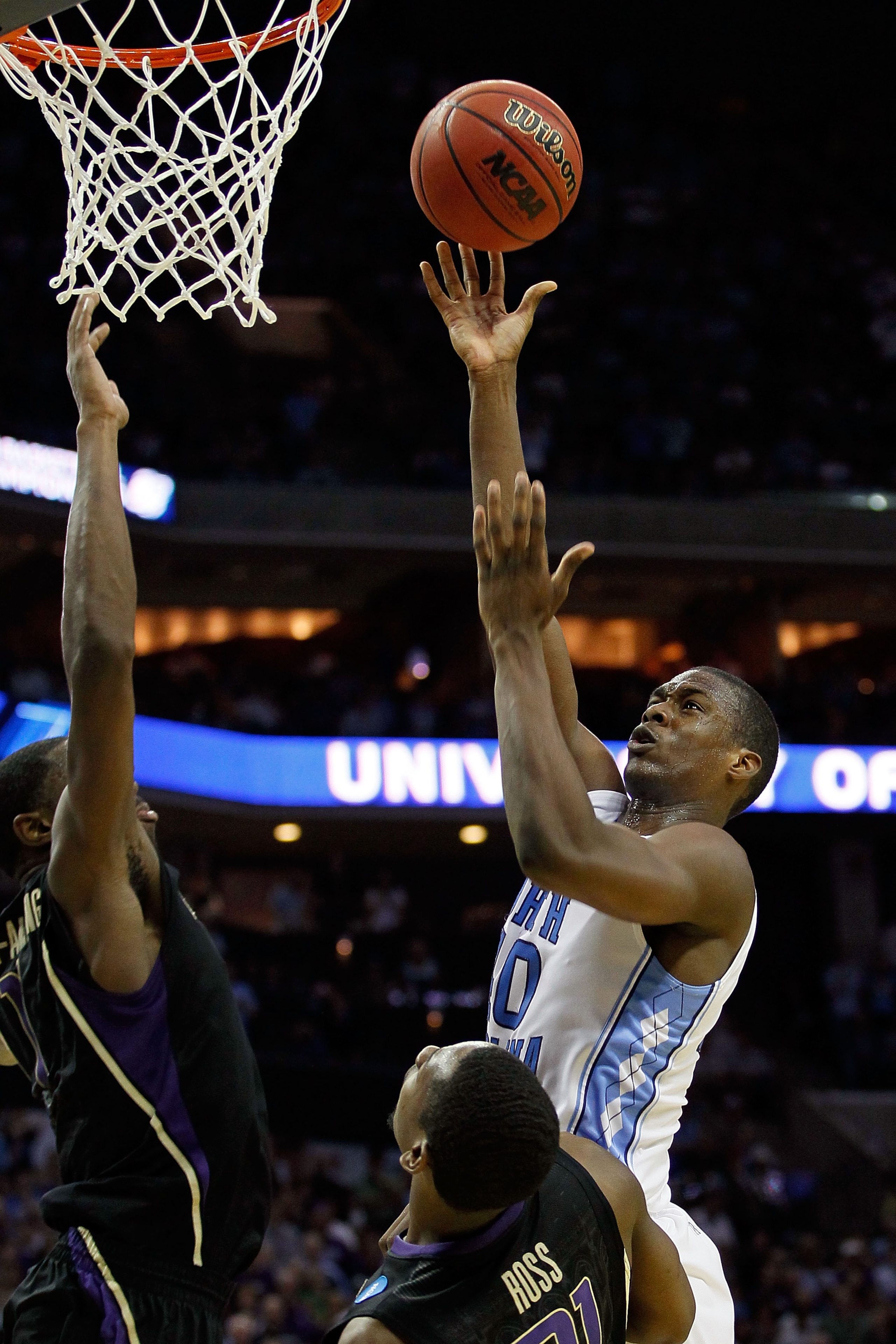 CHARLOTTE, NC - MARCH 20:  Harrison Barnes #40 of the North Carolina Tar Heels shoots over Terrence Ross #31 of the Washington Huskies in the second half during the third round of the 2011 NCAA men's basketball tournament at Time Warner Cable Arena on Mar