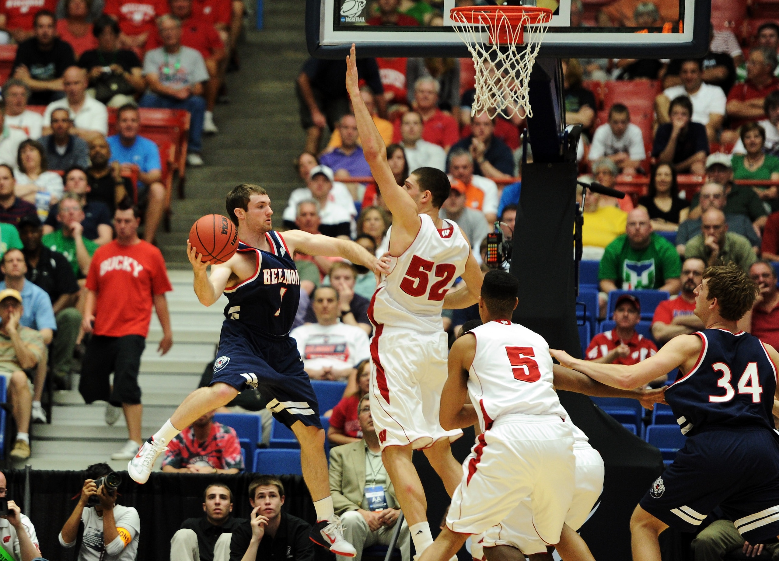 TUCSON, AZ - MARCH 17: Drew Hanlen #1 of the Belmont Bruins passes around Keaton Nankivil #52 of the Wisconsin Badgers during the second round of the 2011 NCAA men's basketball tournament at McKale Center on March 17, 2011 in Tucson, Arizona. (Photo by TUCSON, AZ - MARCH 17: Drew Hanlen #1 of the Belmont Bruins passes around Keaton Nankivil #52 of the Wisconsin Badgers during the second round of the 2011 NCAA men's basketball tournament at McKale Center on March 17, 2011 in Tucson, Arizona. (Photo by