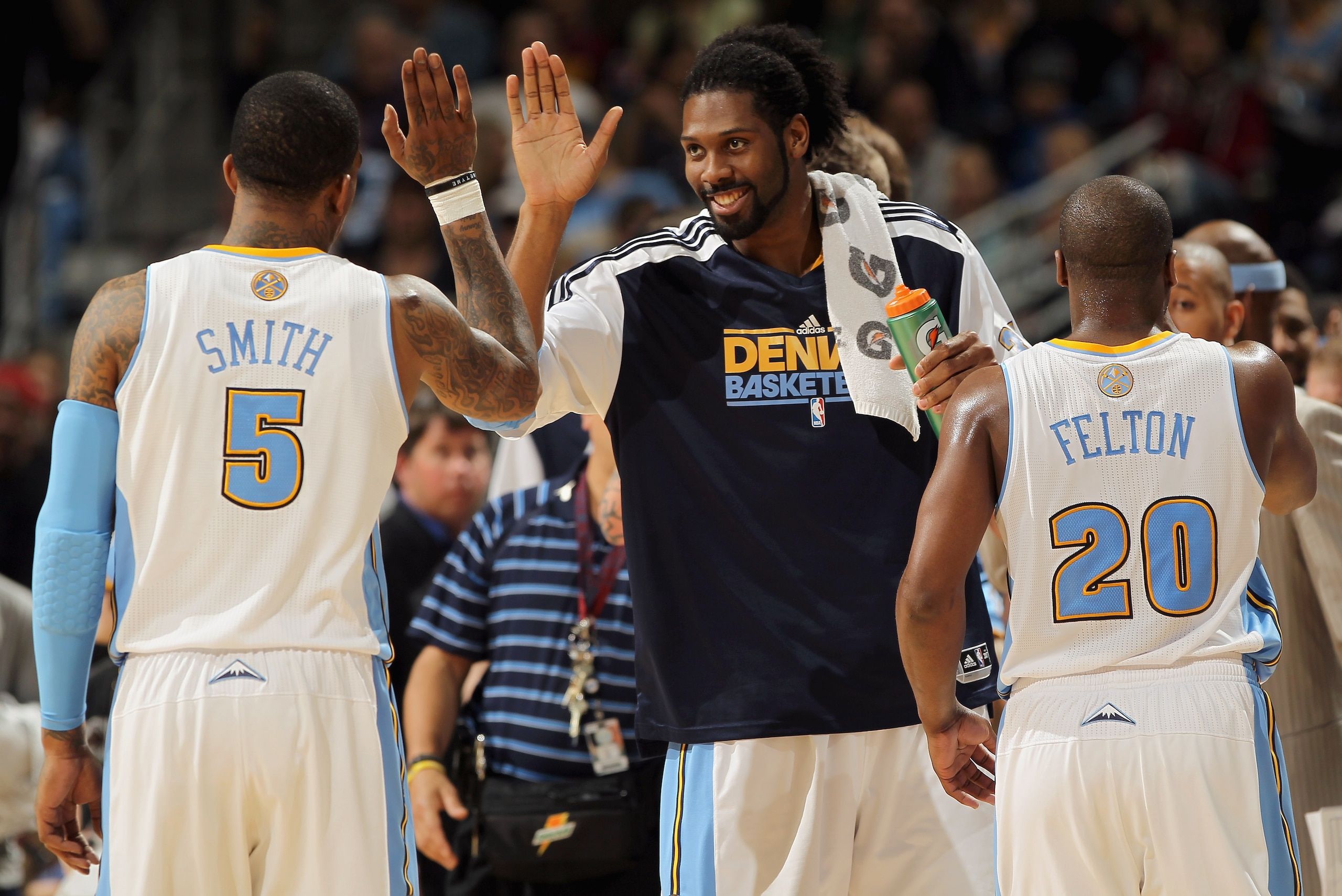 DENVER, CO - MARCH 12:  Nene #31 of the Denver Nuggets welcomes teammates J.R. Smith #5 and Raymond Felton #20 to the bench for a time out against the Detroit Pistons at the Pepsi Center on March 12, 2011 in Denver, Colorado. The Nuggets defeated the Pist