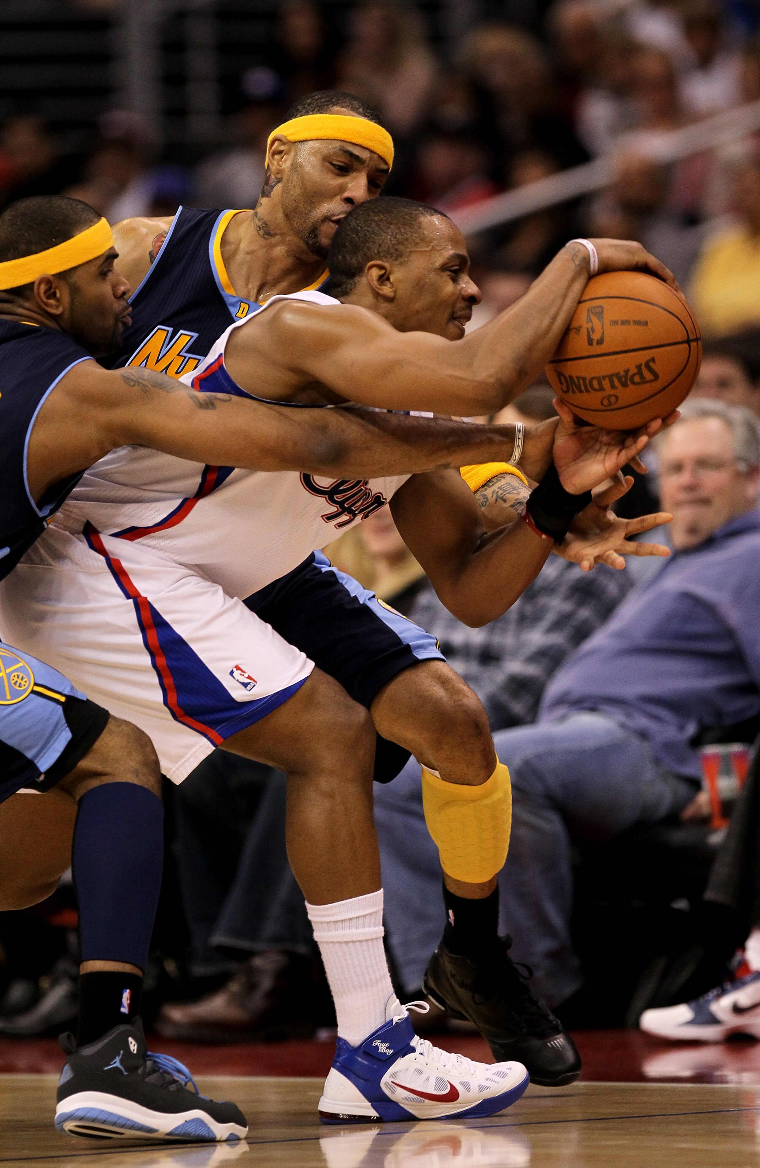 LOS ANGELES, CA - MARCH 05:  Randy Foye #4 of the Los Angeles Clippers controls the ball against he double team of Kenyon Martin #4 and Gary Forbes #0 of the Denver Nuggets at Staples Center on March 5, 2011 in Los Angeles, California.  The Clippers won 1