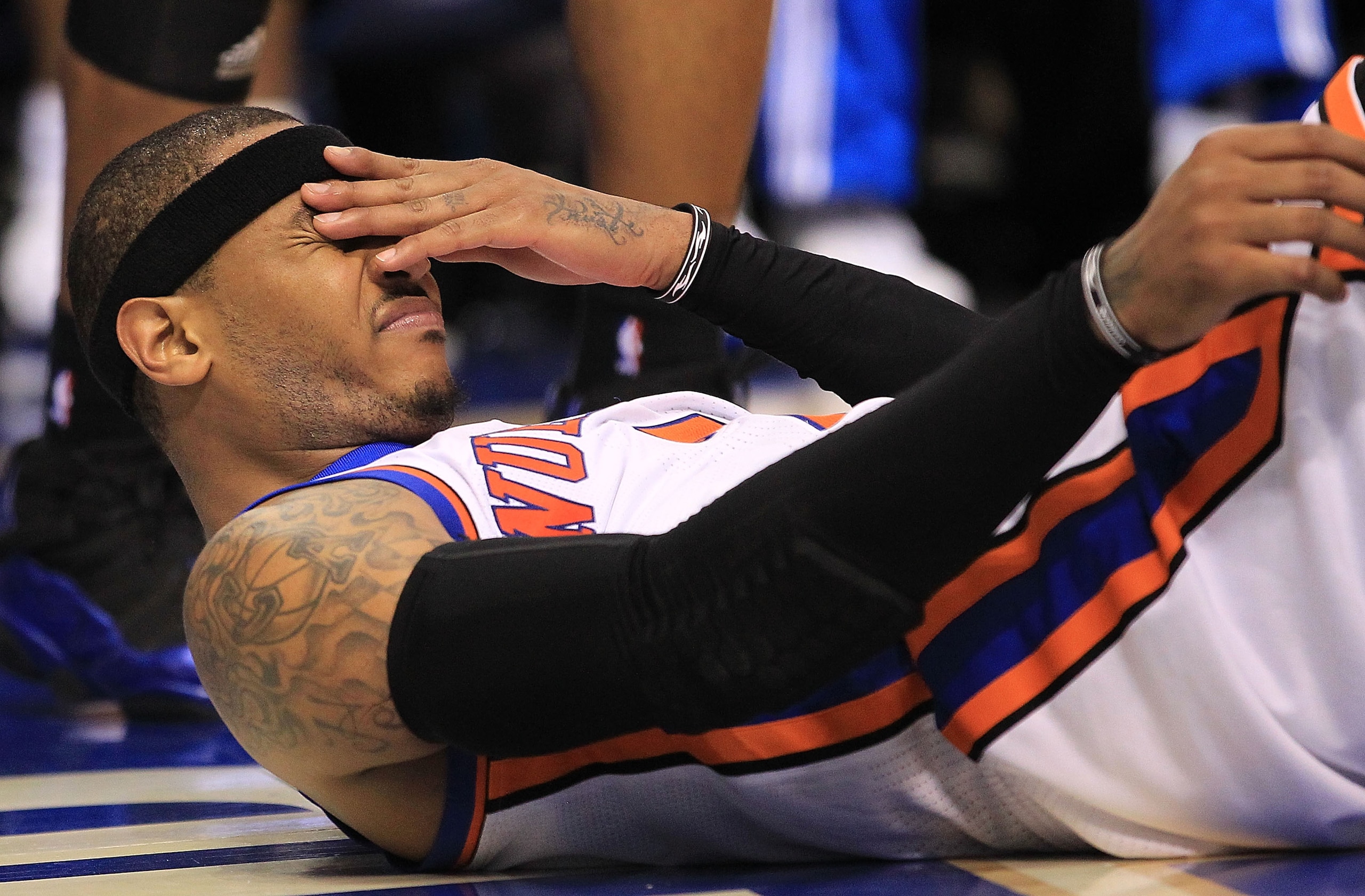 DALLAS, TX - MARCH 10:  Forward Carmelo Anthony #7 of the New York Knicks reacts after falling out of bounds against the Dallas Mavericks at American Airlines Center on March 10, 2011 in Dallas, Texas.  NOTE TO USER: User expressly acknowledges and agrees