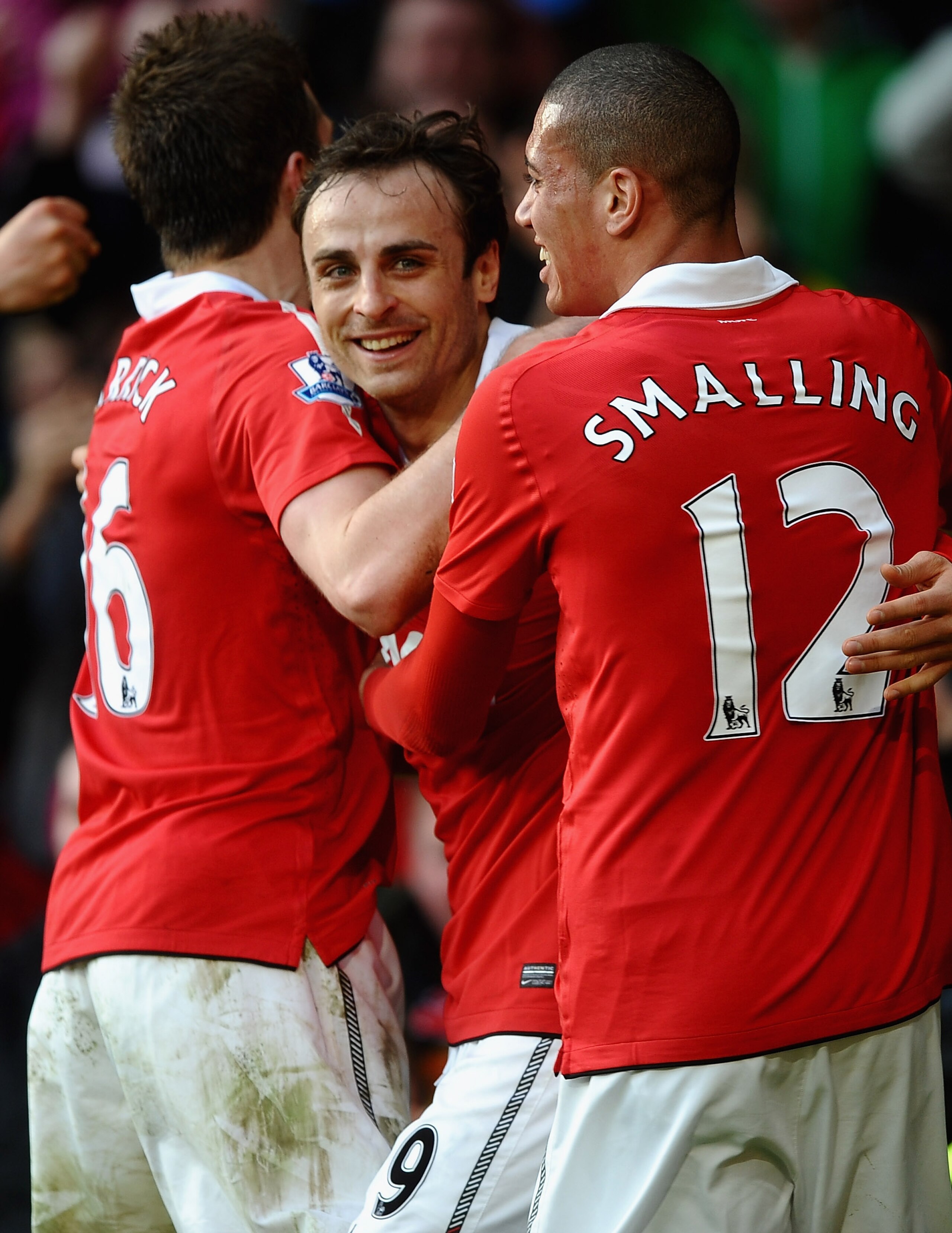 MANCHESTER, ENGLAND - MARCH 19: Dimitar Berbatov of Manchester United is congratulated on scoring the winning goal by Michael Carrick and Chris Smalling during the Barclays Premier League match between Manchester United and Bolton Wanderers at Old Traffor