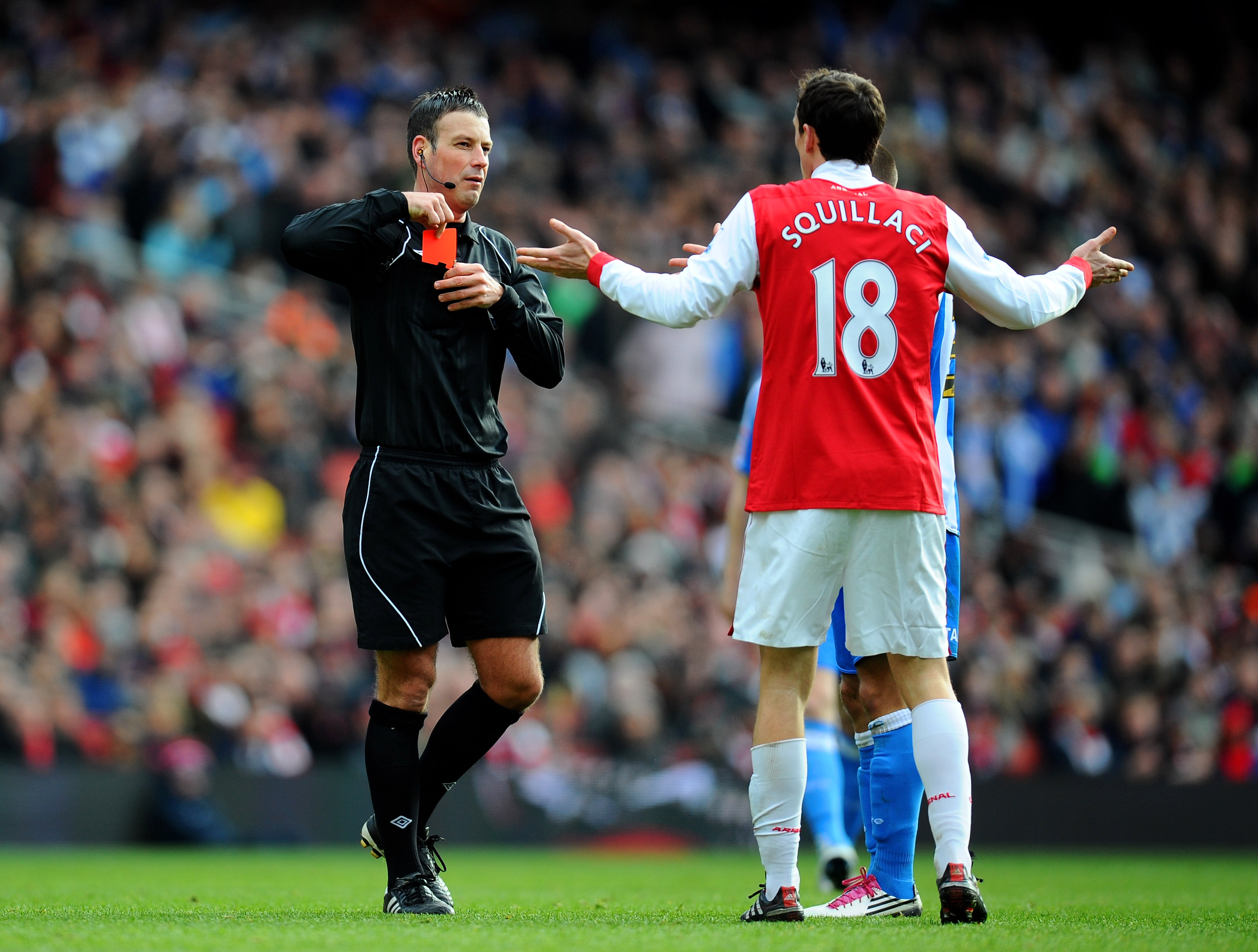 LONDON, ENGLAND - JANUARY 30:  Sebastien Squillaci #30 of Arsenal reacts as he is shown a straight red card by Referee Mark Clattenburg after his foul on Jack Hunt of Huddersfield during the FA Cup sponsored by E.ON fourth round match between Arsenal and