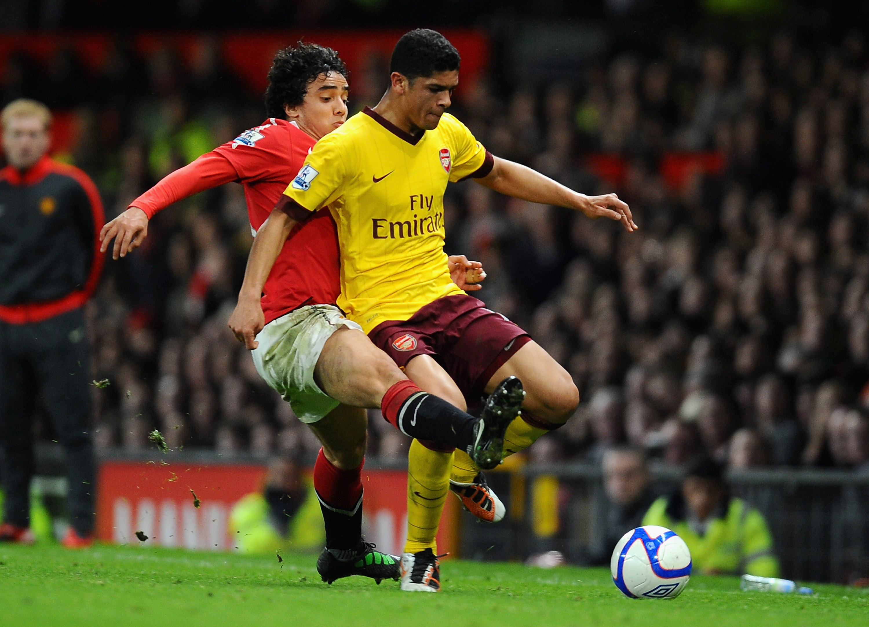 MANCHESTER, ENGLAND - MARCH 12: Rafael Da Silva of Manchester United and Denilson of Arsenal battle for the ball during the FA Cup sponsored by E.On Sixth Round match between Manchester United and Arsenal at Old Trafford on March 12, 2011 in Manchester, E