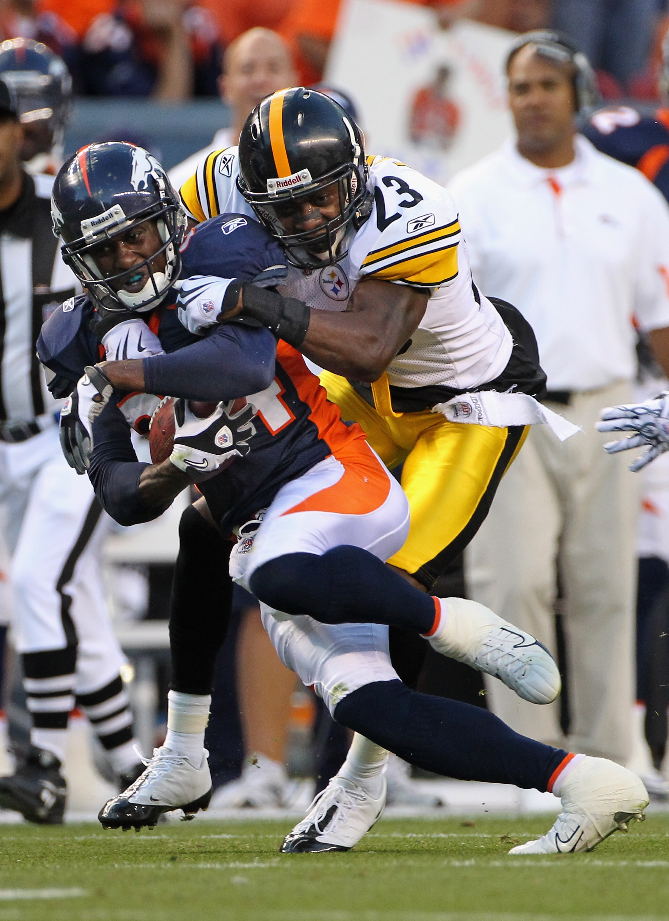DENVER - AUGUST 29:  Wide Receiver Brandon Lloyd #84 of the Denver Broncos makes a reception and is tackled by cornerback Keenan Lewis #23 of the Pittsburgh Steelers who was called for a personal foul on the play during preseason NFL action at INVESCO Fie