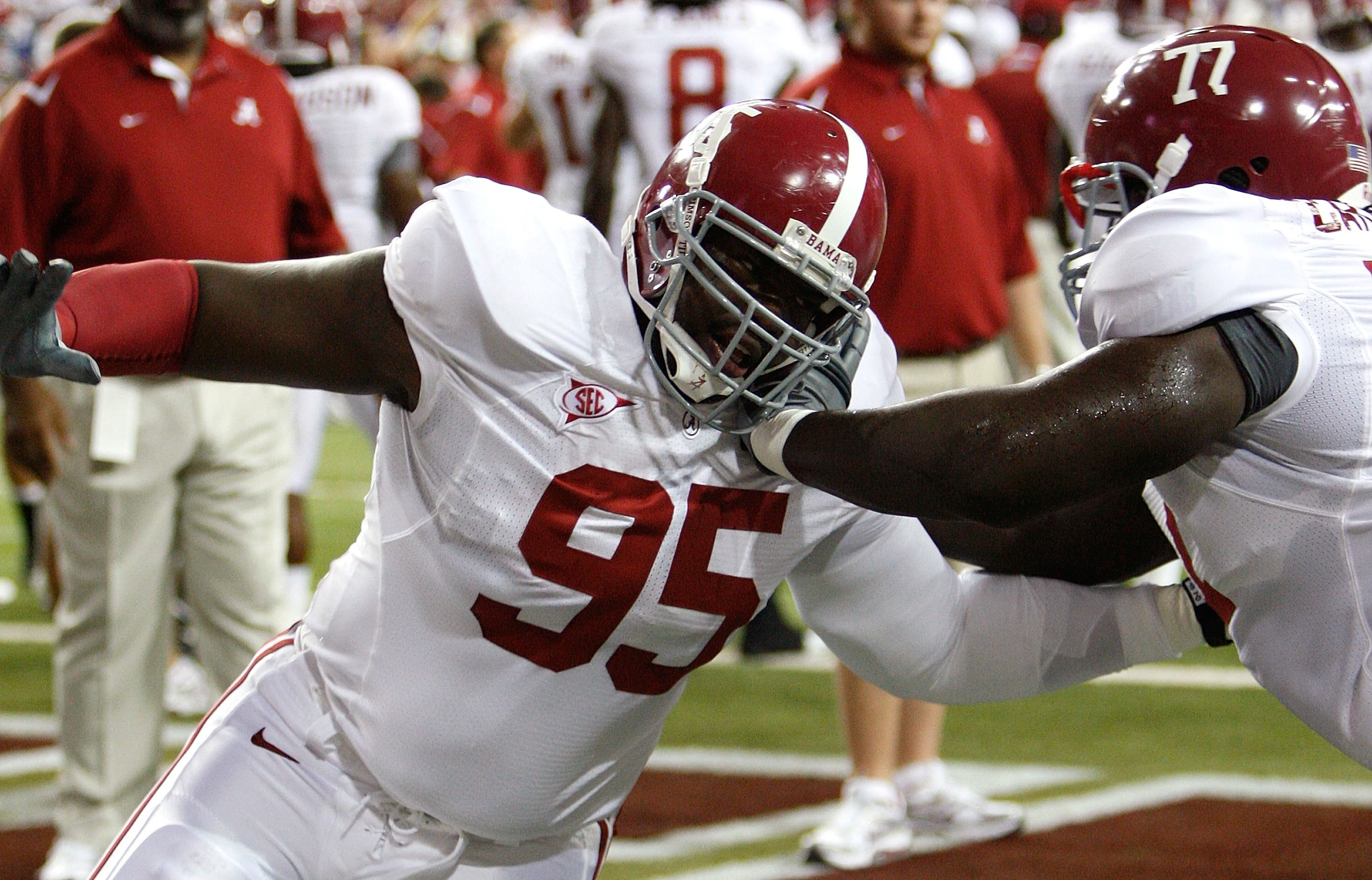 ATLANTA - SEPTEMBER 05:  Defensive lineman Brandon Deaderick #95 of the Alabama Crimson Tide warms up with James Carpenter #77 before facing the Virginia Tech Hokies during the Chick-fil-A Kickoff Game at Georgia Dome on September 5, 2009 in Atlanta, Geor