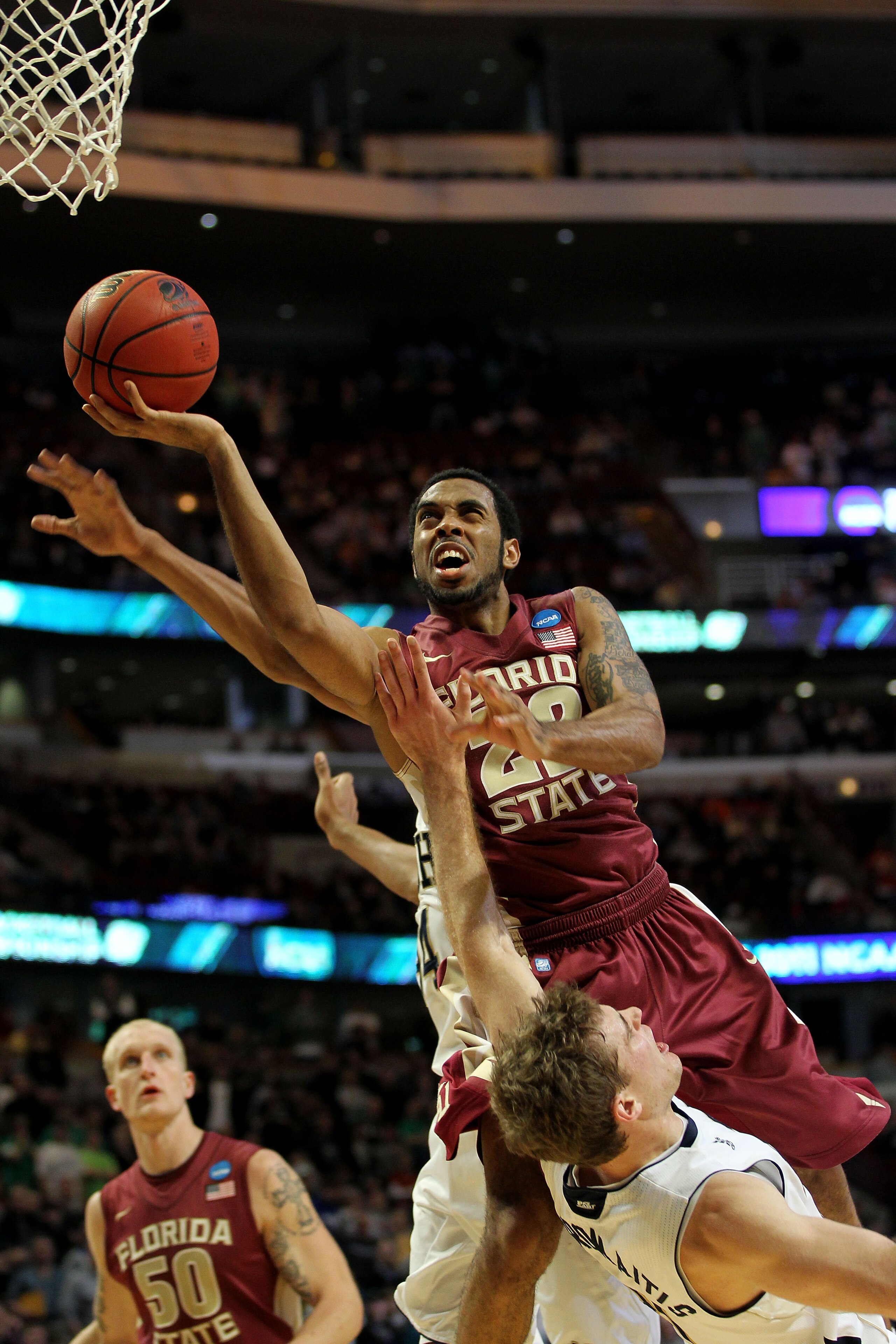 CHICAGO, IL - MARCH 20:  Derwin Kitchen #22 of the Florida State Seminoles shoots against Tim Abromaitis #21 of the Notre Dame Fighting Irish in the second half during the third round of the 2011 NCAA men's basketball tournament at the United Center on Ma