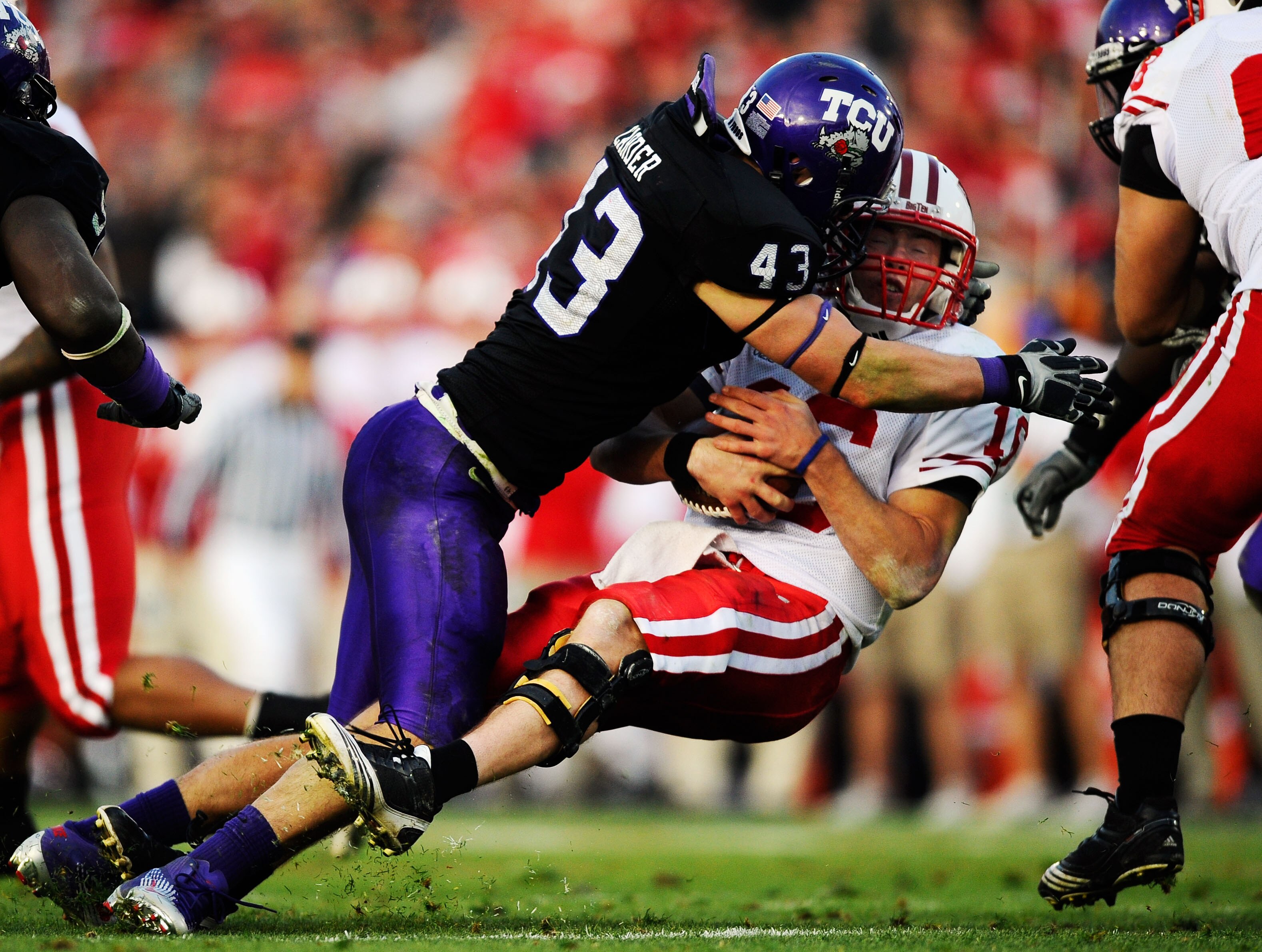 PASADENA, CA - JANUARY 01:  Quarterback Scott Tolzien #16 of the Wisconsin Badgers is sacked by linebacker Tank Carder #43 of the TCU Horned Frogs during the 97th Rose Bowl game on January 1, 2011 in Pasadena, California.  (Photo by Kevork Djansezian/Gett