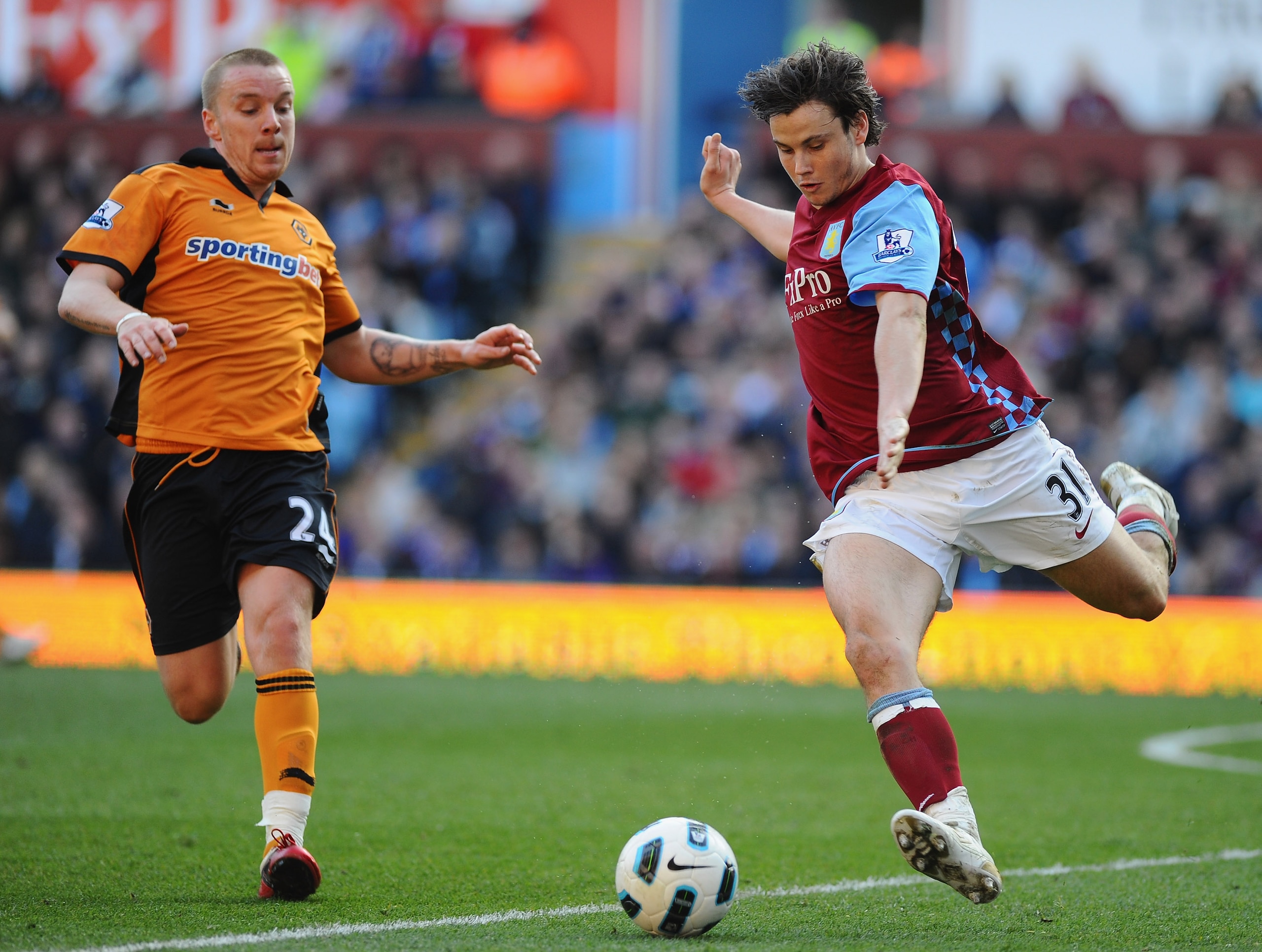 BIRMINGHAM, ENGLAND - MARCH 19:  Chris Herd of Aston Villa is challenged by Ronald Zubar of Wolves during the Barclays Premier League match between Aston Villa and Wolverhampton Wanderers at Villa Park on March 19, 2011 in Birmingham, England.  (Photo by 