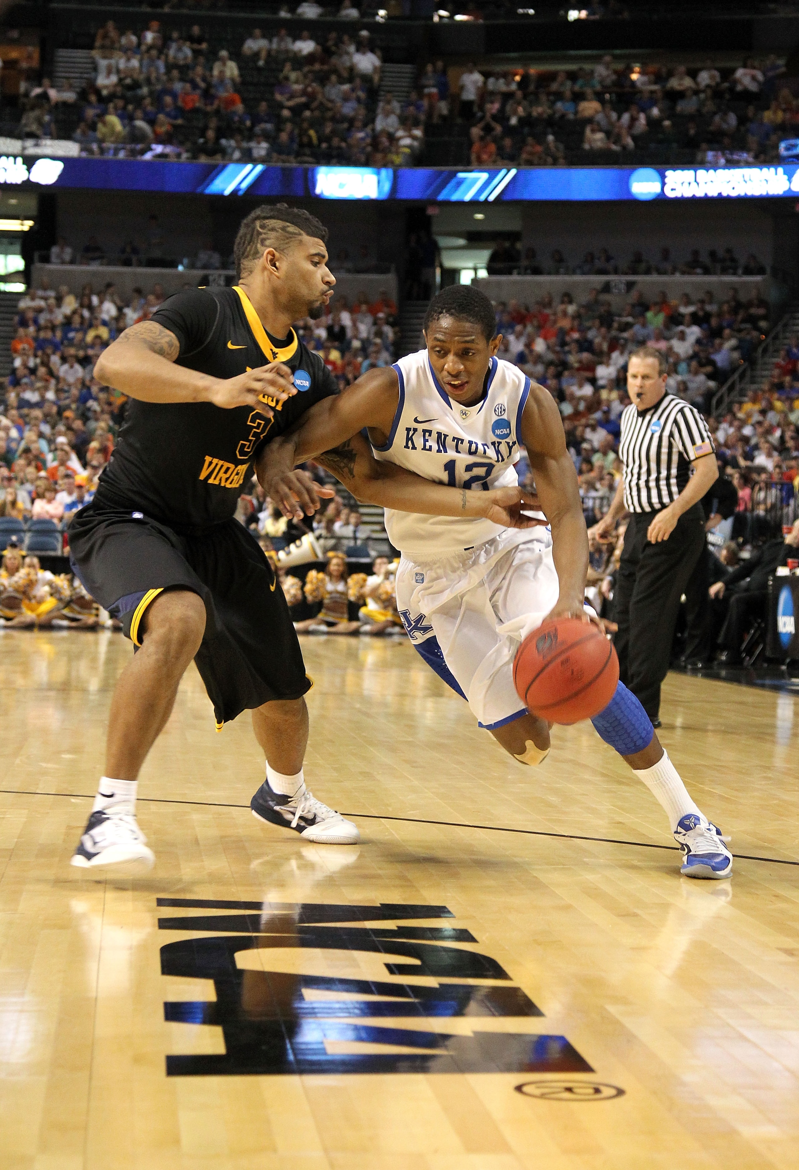 TAMPA, FL - MARCH 19: Brandon Knight #12 of the Kentucky Wildcats drives against Casey Mitchell #3 of the West Virginia Mountaineers during the third round of the 2011 NCAA men's basketball tournament at St. Pete Times Forum on March 19, 2011 in Tampa, F TAMPA, FL - MARCH 19: Brandon Knight #12 of the Kentucky Wildcats drives against Casey Mitchell #3 of the West Virginia Mountaineers during the third round of the 2011 NCAA men's basketball tournament at St. Pete Times Forum on March 19, 2011 in Tampa, F