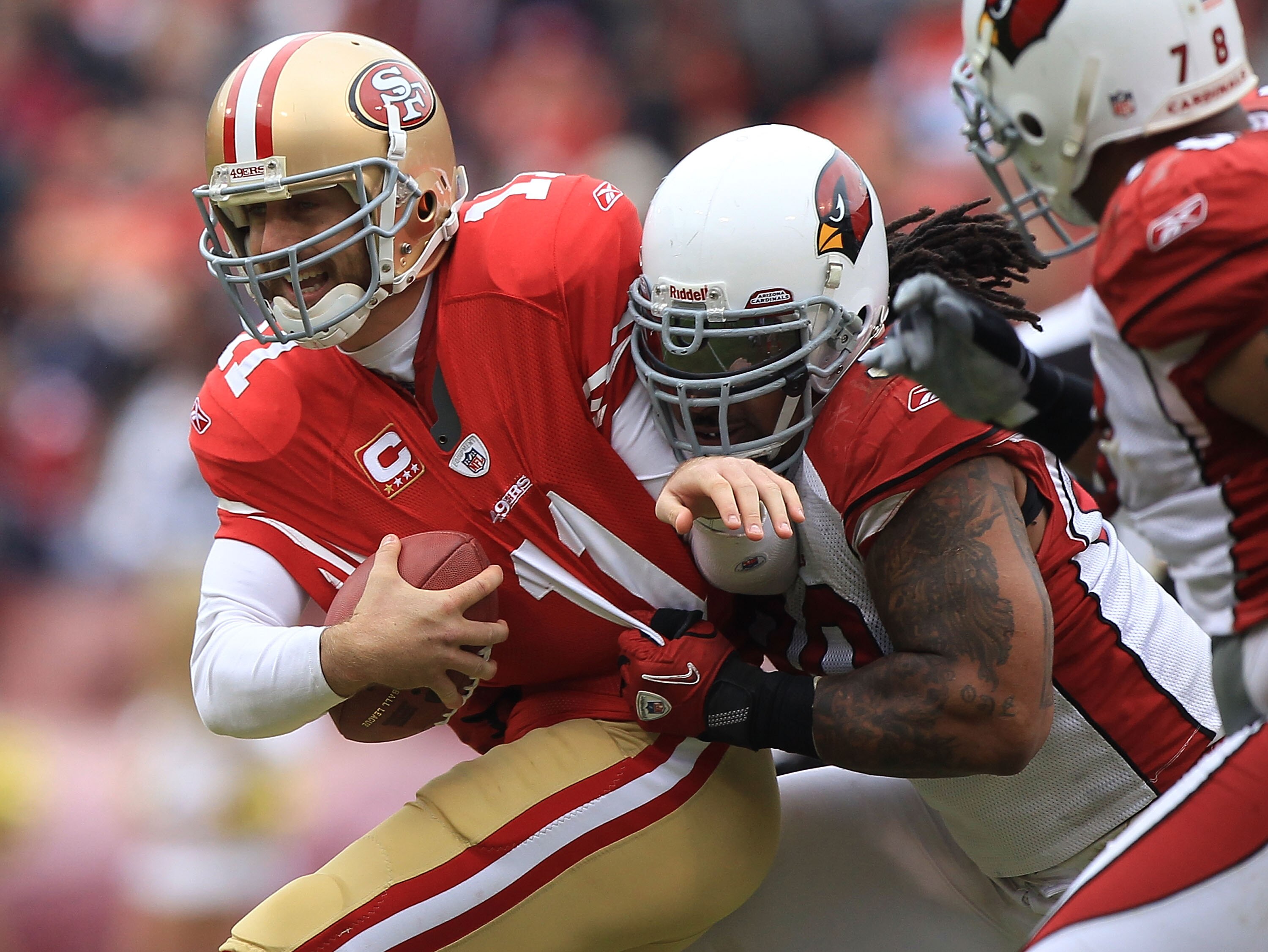 SAN FRANCISCO, CA - JANUARY 02:    Alex Smith #11 of the San Francisco 49ers is sacked by Darnell Dockett #90 of the Arizona Cardinals during an NFL game at Candlestick Park on January 2, 2011 in San Francisco, California.  (Photo by Jed Jacobsohn/Getty I