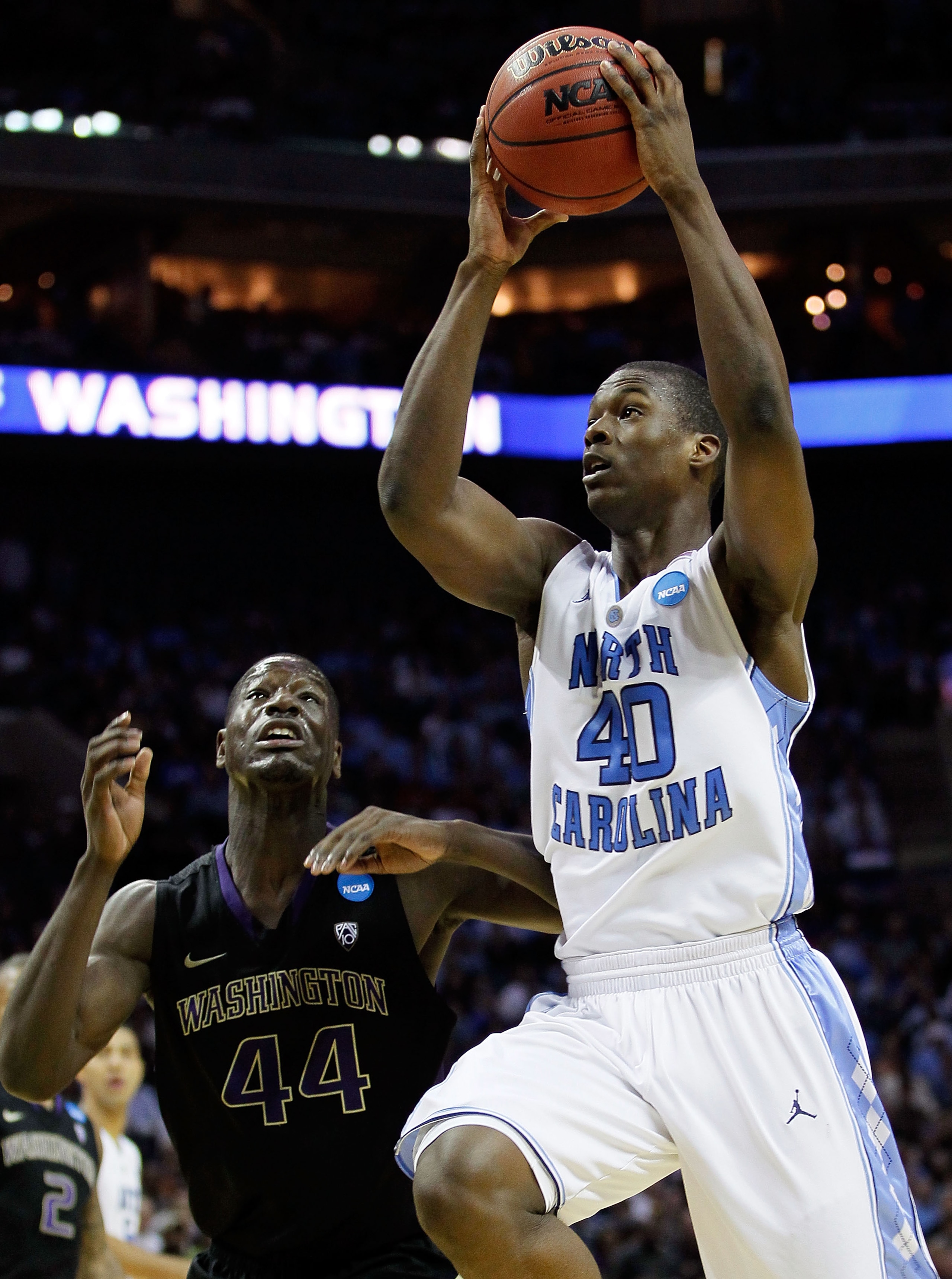 CHARLOTTE, NC - MARCH 20:  Harrison Barnes #40 of the North Carolina Tar Heels goes up for a shot against Darnell Gant #44 of the Washington Huskies in the second half during the third round of the 2011 NCAA men's basketball tournament at Time Warner Cabl