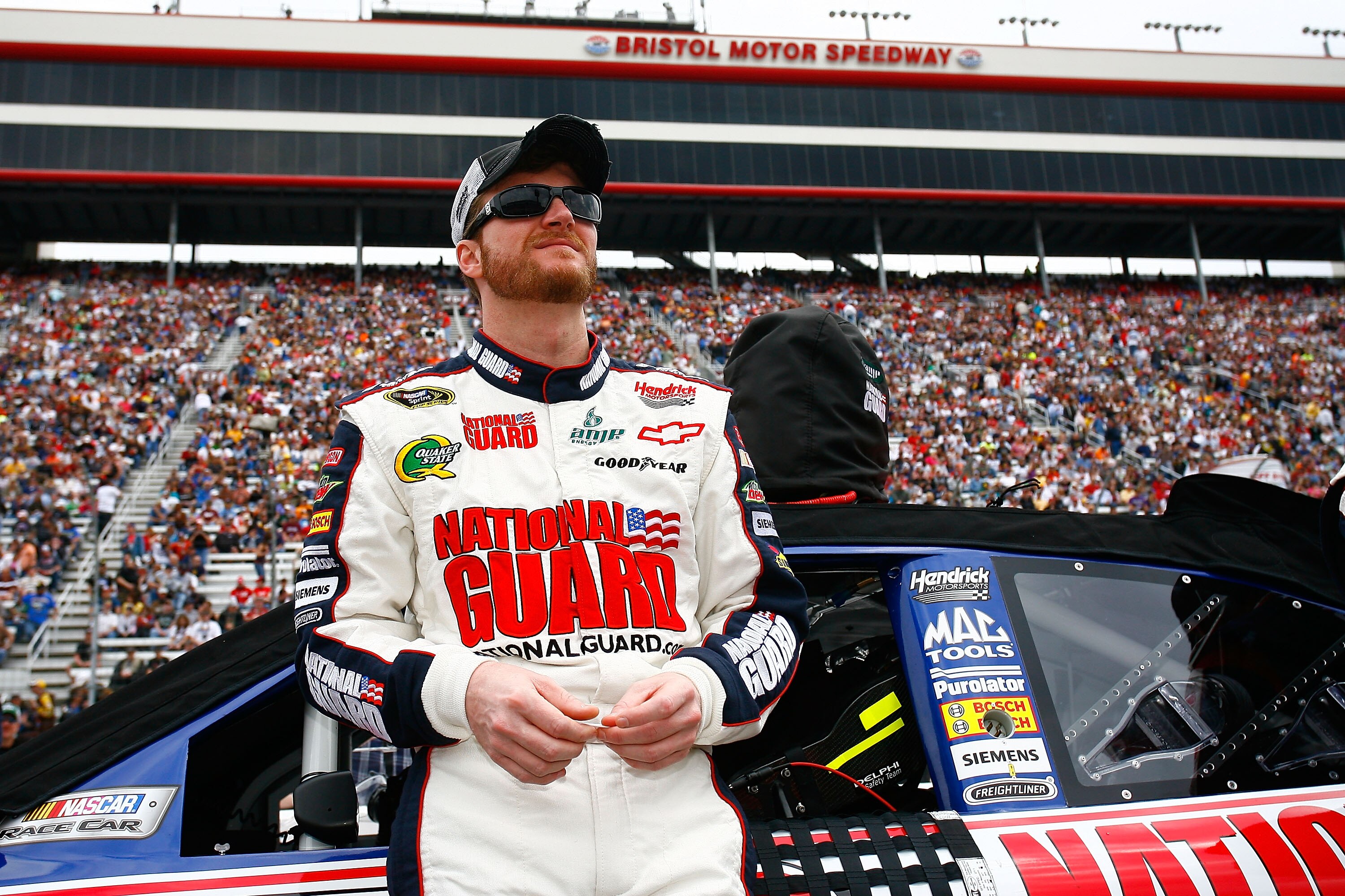 BRISTOL, TN - MARCH 20:  Dale Earnhardt Jr., stands beside the #88 AMP Energy/National Guard Chevrolet, during pre-race activities for the NASCAR Sprint Cup Series Jeff Byrd 500 Presented By Food City at Bristol Motor Speedway on March 20, 2011 in Bristol