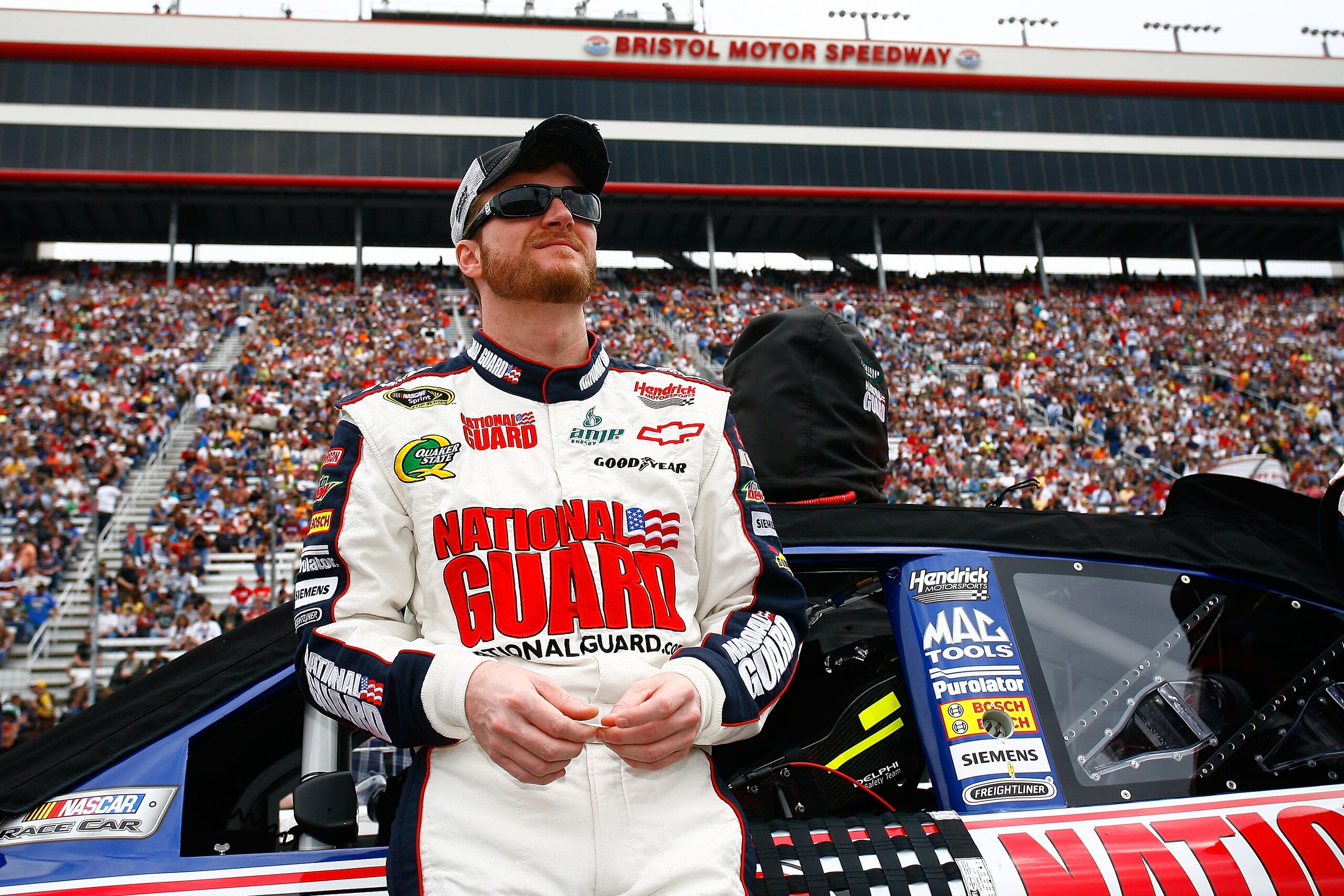 BRISTOL, TN - MARCH 20: Dale Earnhardt Jr., stands beside the #88 AMP Energy/National Guard Chevrolet, during pre-race activities for the NASCAR Sprint Cup Series Jeff Byrd 500 Presented By Food City at Bristol Motor Speedway on March 20, 2011 in Bristol BRISTOL, TN - MARCH 20: Dale Earnhardt Jr., stands beside the #88 AMP Energy/National Guard Chevrolet, during pre-race activities for the NASCAR Sprint Cup Series Jeff Byrd 500 Presented By Food City at Bristol Motor Speedway on March 20, 2011 in Bristol