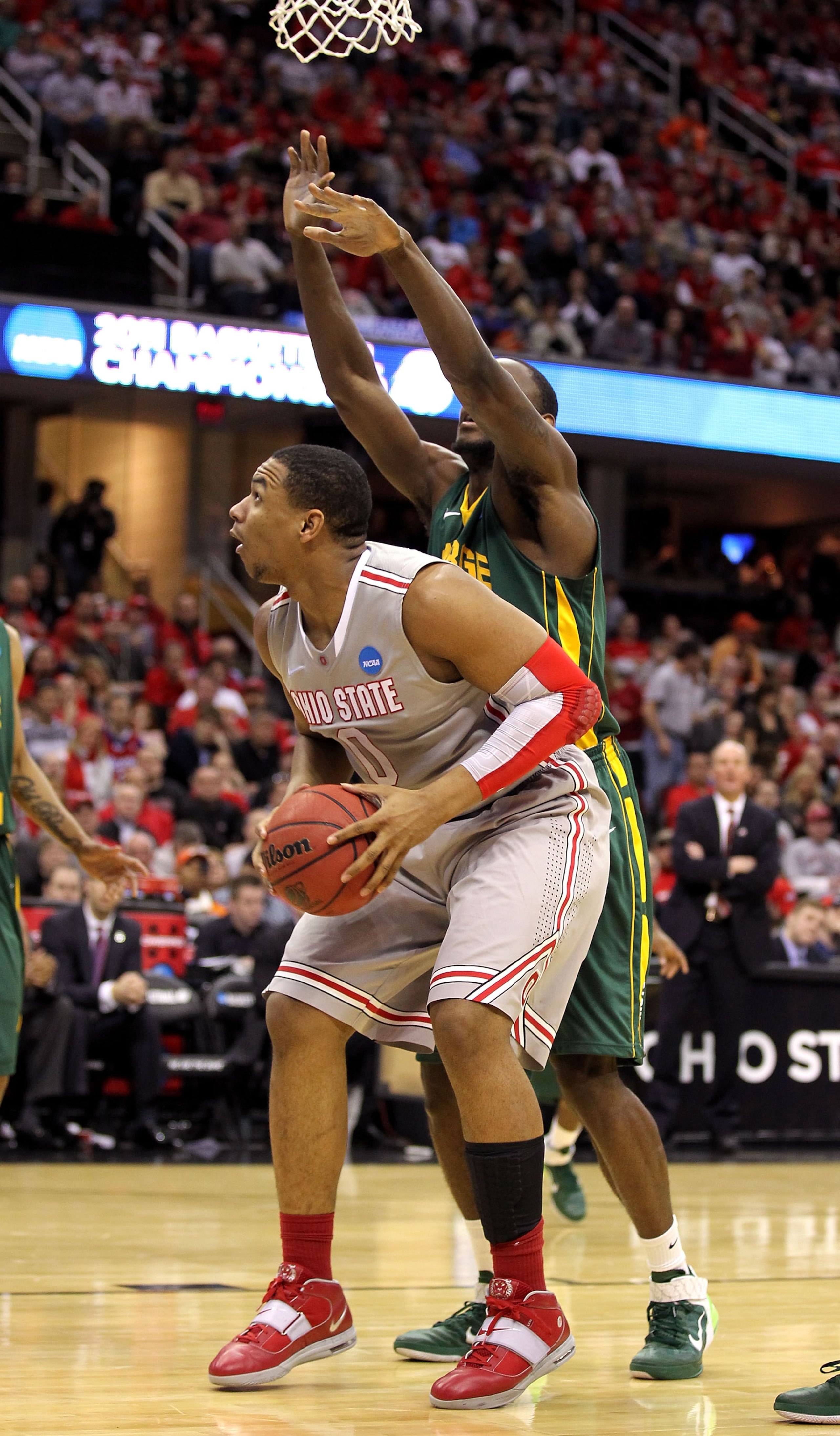 CLEVELAND, OH - MARCH 20: Jared Sullinger #0 of the Ohio State Buckeyes handles the ball against Mike Morrison #22 of the George Mason Patriots during the third of the 2011 NCAA men's basketball tournament at Quicken Loans Arena on March 20, 2011 in Cleve