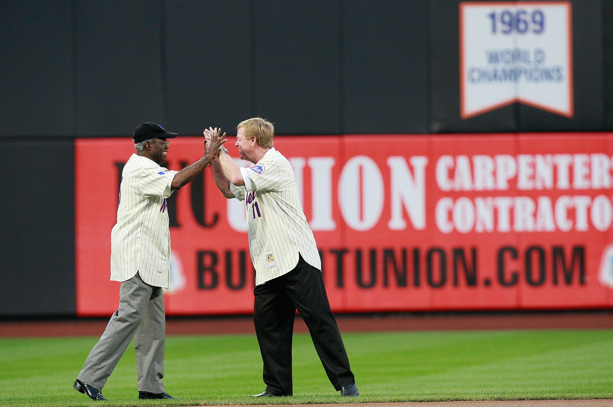 NEW YORK - AUGUST 22:  Ed Charles high fives Wayne Garrett during the presentation commemorating the New York Mets 40th anniversary of the 1969 World Championship team on August 22, 2009 at Citi Field in the Flushing neighborhood of the Queens borough of