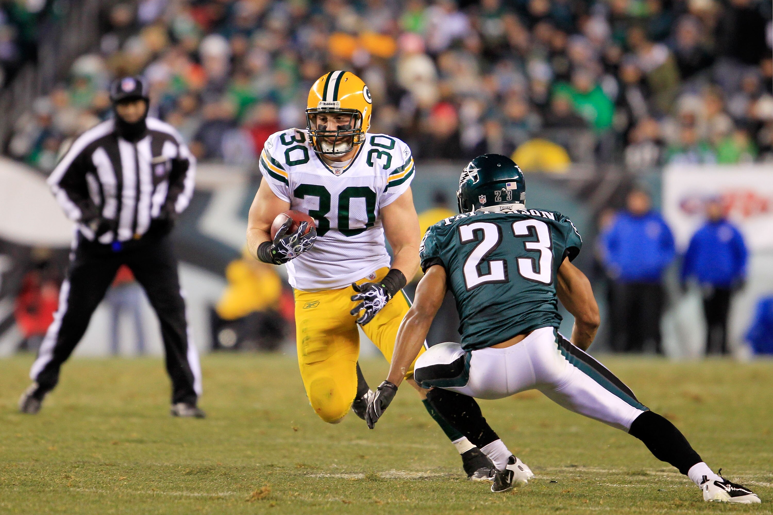 PHILADELPHIA, PA - JANUARY 09:  John Kuhn #30 of the Green Bay Packers runs down field against Dimitri Patterson #23 of the Philadelphia Eagles during the 2011 NFC wild card playoff game at Lincoln Financial Field on January 9, 2011 in Philadelphia, Penns