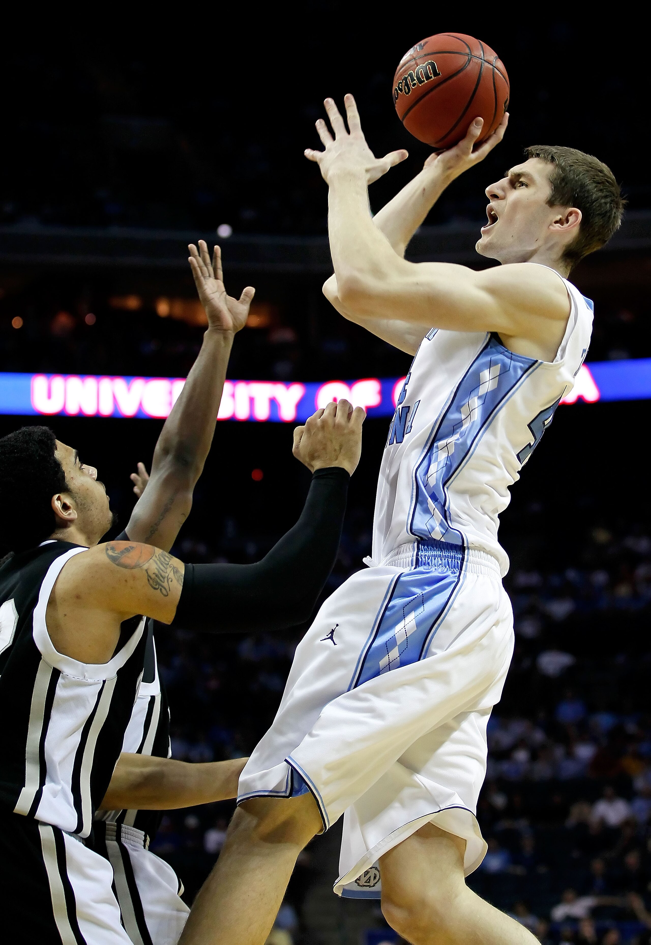 CHARLOTTE, NC - MARCH 18:  Tyler Zeller #44 of the North Carolina Tar Heels shoots over Julian Boyd #42 of the Long Island Blackbirds in the first half during the second round of the 2011 NCAA men's basketball tournament at Time Warner Cable Arena on Marc