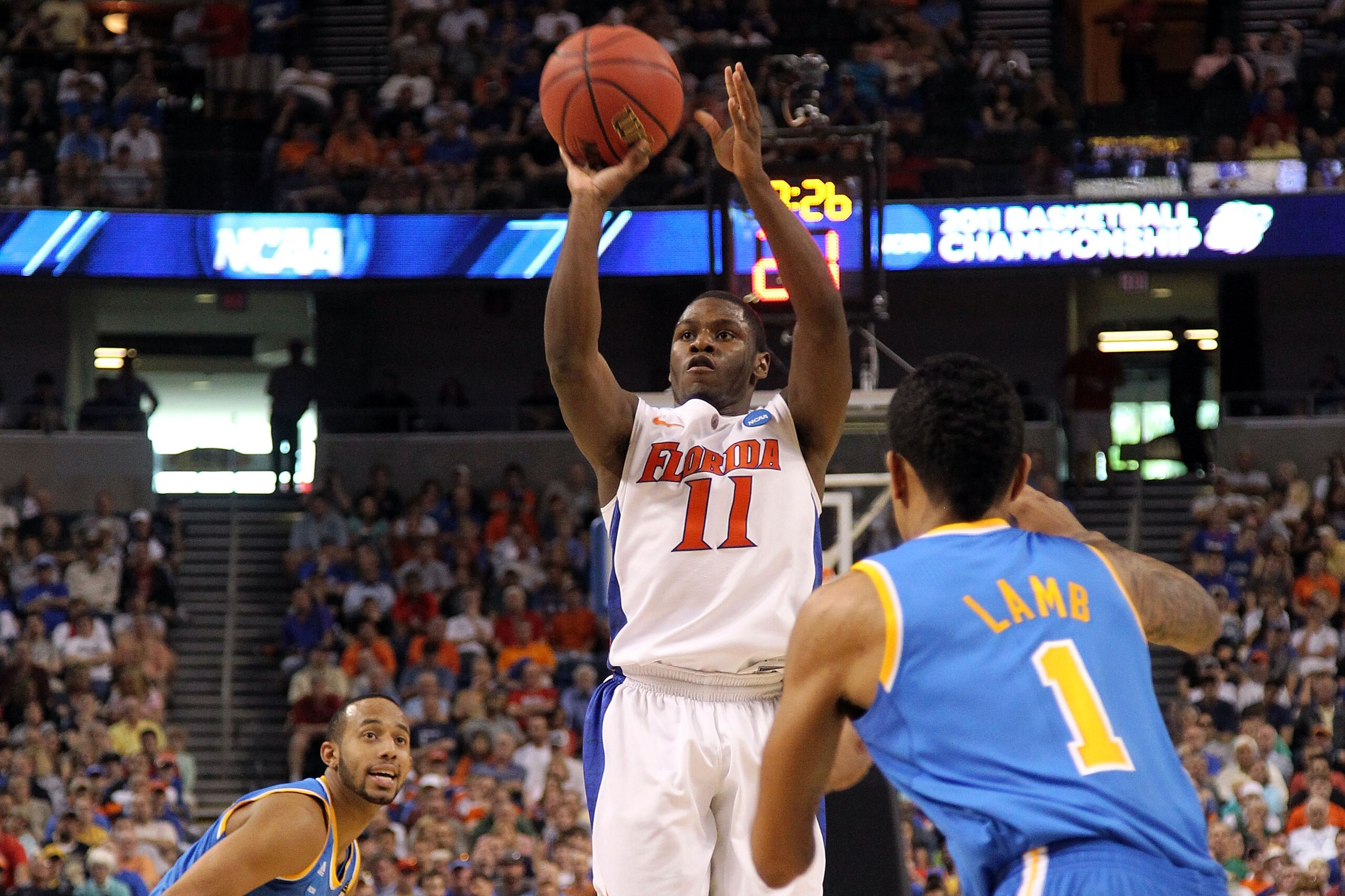 TAMPA, FL - MARCH 19:  Erving Walker #11 of the Florida Gators attempts a shot in the first half against the Tyler Lamb #1 of the UCLA Bruins during the third round of the 2011 NCAA men's basketball tournament at St. Pete Times Forum on March 19, 2011 in 