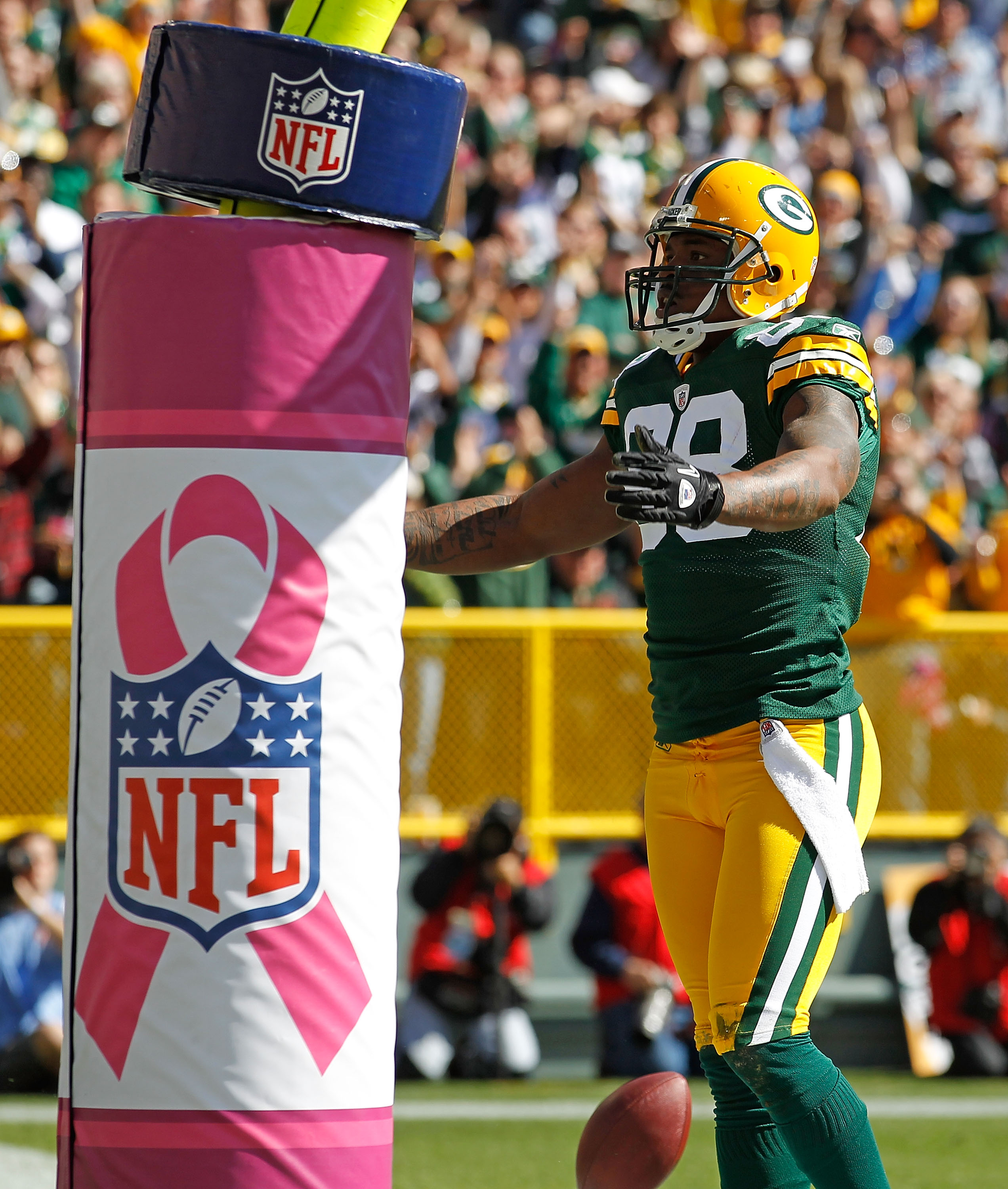 GREEN BAY, WI - OCTOBER 03: Jermichael Finley #88 of the Green Bay Packers celebrates a touchdown catch against the Detroit Lions in front of a goal post wrapped with a breast cancer awarness pad at Lambeau Field on October 3, 2010 in Green Bay, Wisconsin