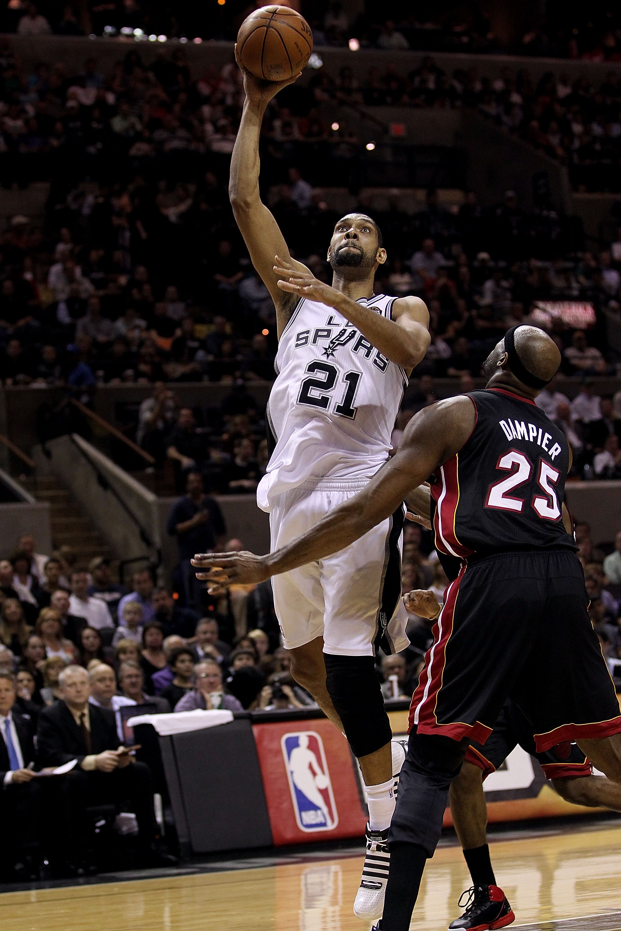 SAN ANTONIO, TX - MARCH 04:  Forward Tim Duncan #21 of the San Antonio Spurs takes a shot against Erick Dampier #25 of the Miami Heat at AT&T Center on March 4, 2011 in San Antonio, Texas.   NOTE TO USER: User expressly acknowledges and agrees that, by do