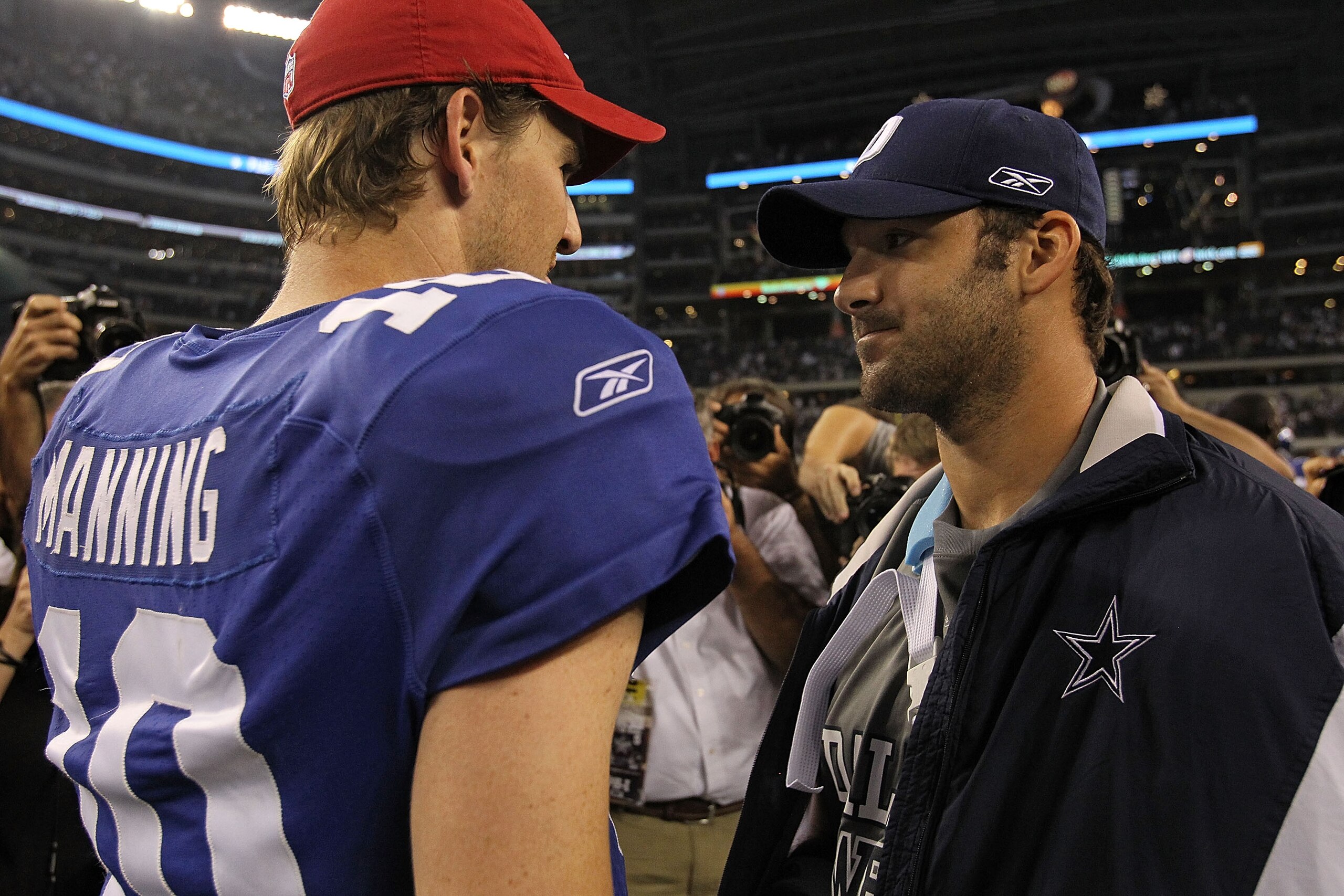 ARLINGTON, TX - OCTOBER 25:  Quarterback Tony Romo #9 of the Dallas Cowboys talks with Eli Manning #10 of the New York Giants after a game at Cowboys Stadium on October 25, 2010 in Arlington, Texas.  (Photo by Ronald Martinez/Getty Images)