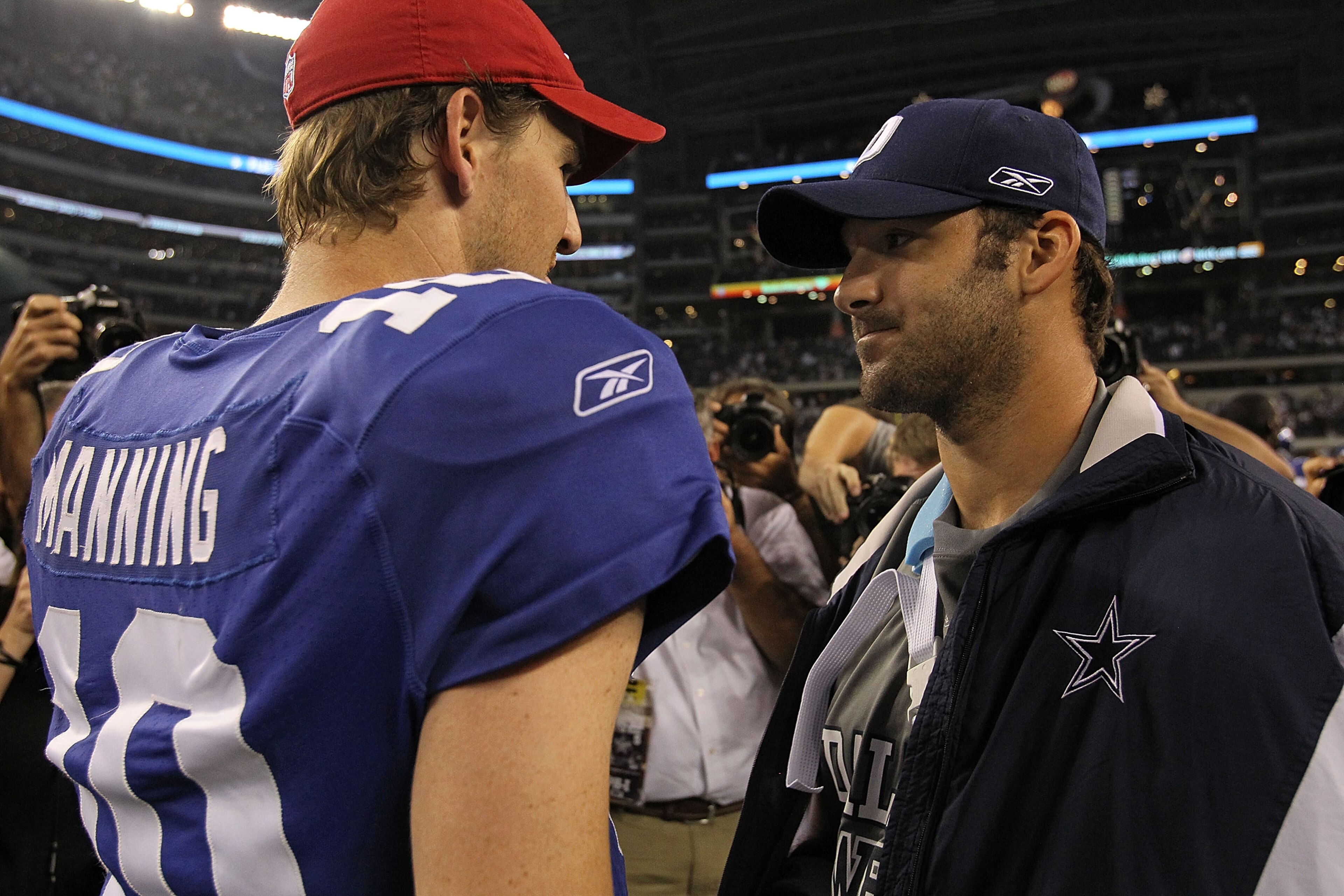 ARLINGTON, TX - OCTOBER 25:  Quarterback Tony Romo #9 of the Dallas Cowboys talks with Eli Manning #10 of the New York Giants after a game at Cowboys Stadium on October 25, 2010 in Arlington, Texas.  (Photo by Ronald Martinez/Getty Images)