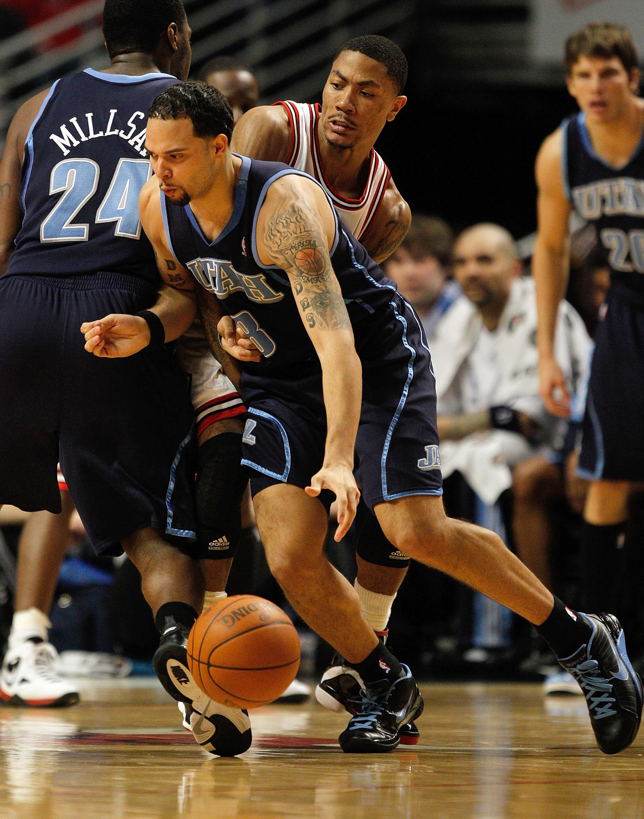 CHICAGO - MARCH 09: Deron Williams #8 of the Utah Jazz moves against Derrick Rose #1 of the Chicago Bulls as teammate Paul Millsap #24 sets a screen at the United Center on March 9, 2010 in Chicago, Illinois. The Jazz defeated the Bulls 132-108. NOTE TO U