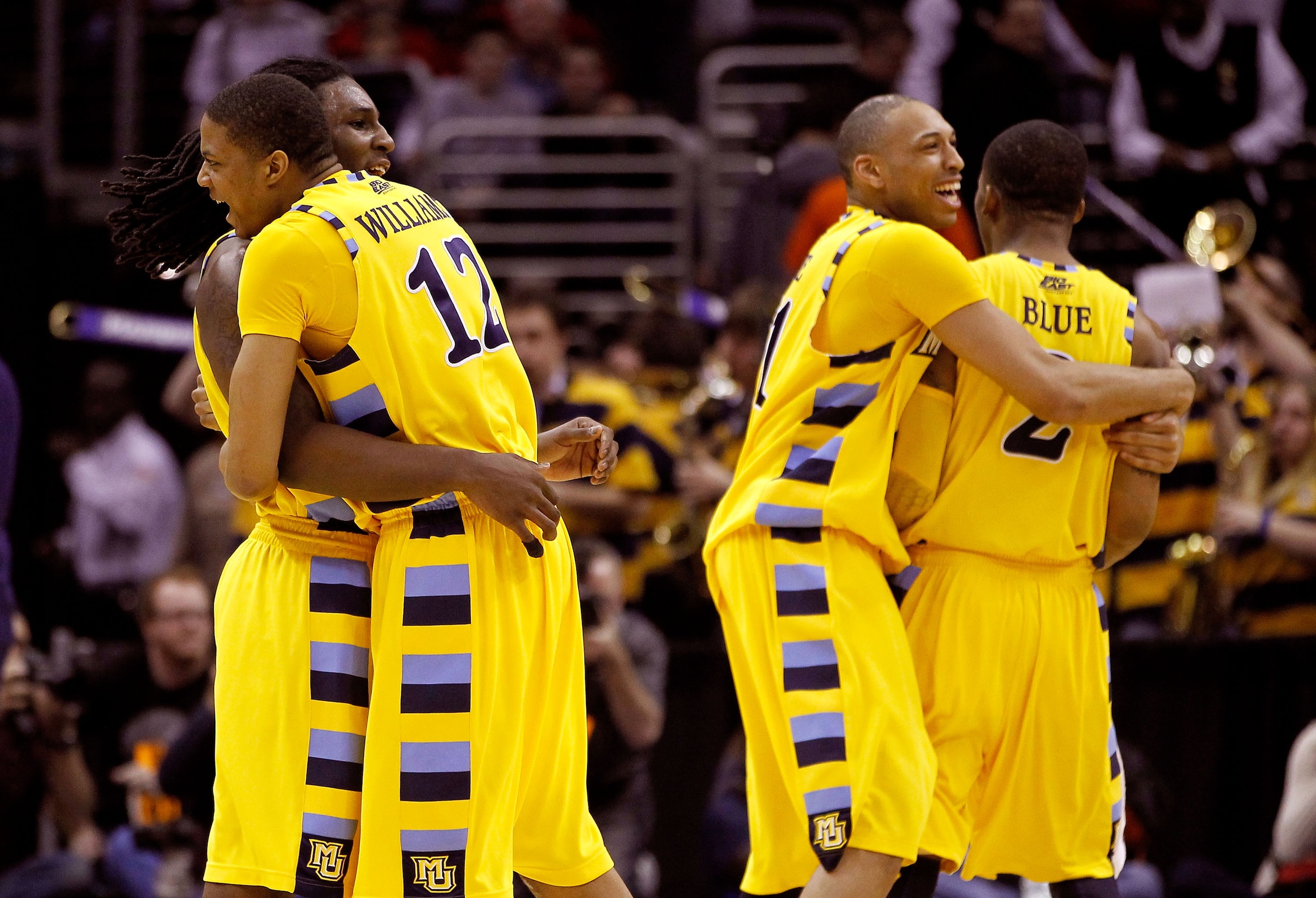 CLEVELAND, OH - MARCH 20:  Jae Crowder #32, Erik Williams #12, Joseph Fulce #21 and Vander Blue #2 of the Marquette Golden Eagles hug after defeating the Syracuse Orange during the third of the 2011 NCAA men's basketball tournament at Quicken Loans Arena