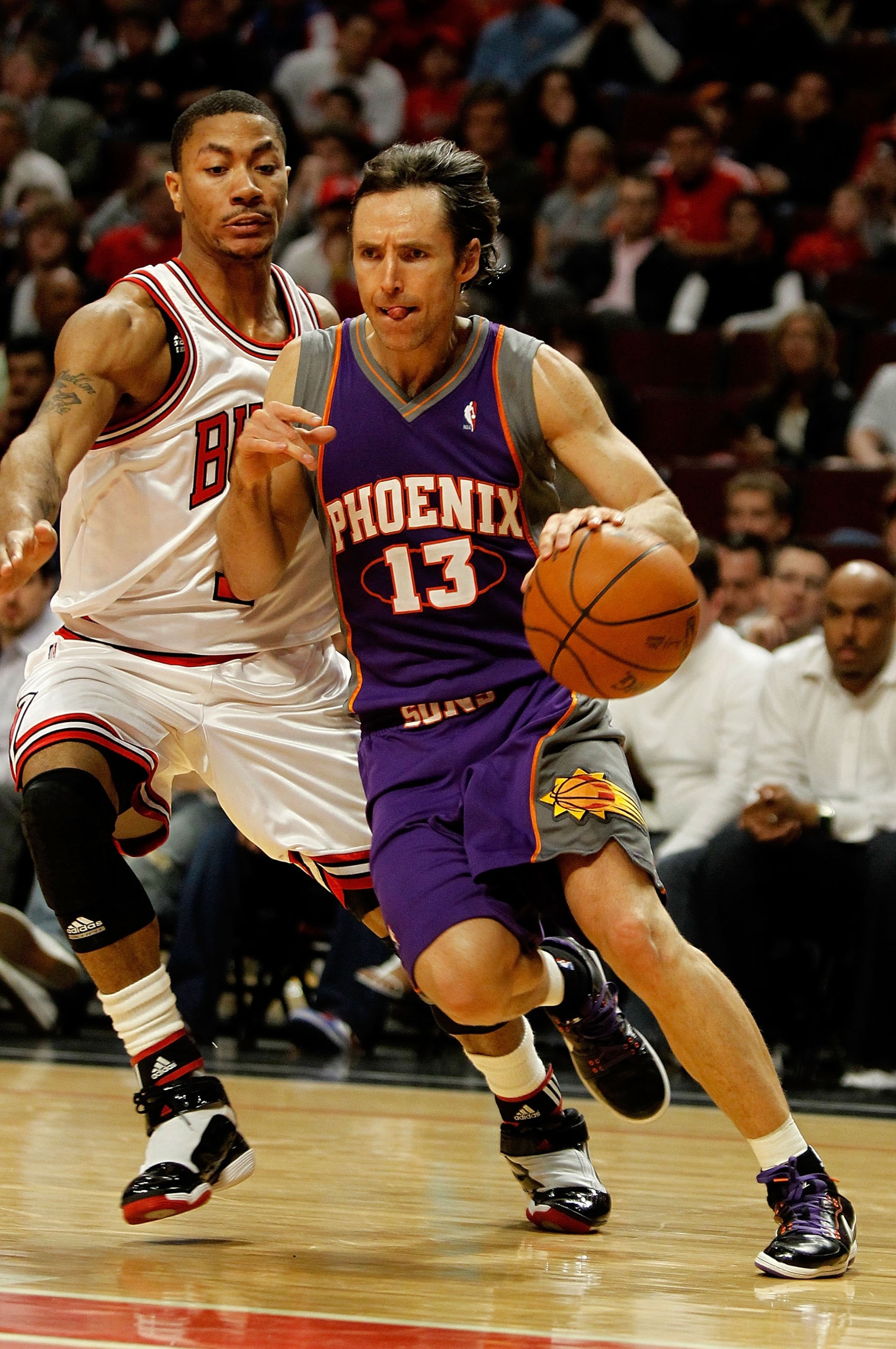 CHICAGO - MARCH 30: Steve Nash #13 of the Phoenix Suns drives around Derrick Rose #1 of the Chicago Bulls at the United Center on March 30, 2010 in Chicago, Illinois. The Suns defeated the Bulls 111-105. NOTE TO USER: User expressly acknowledges and agree