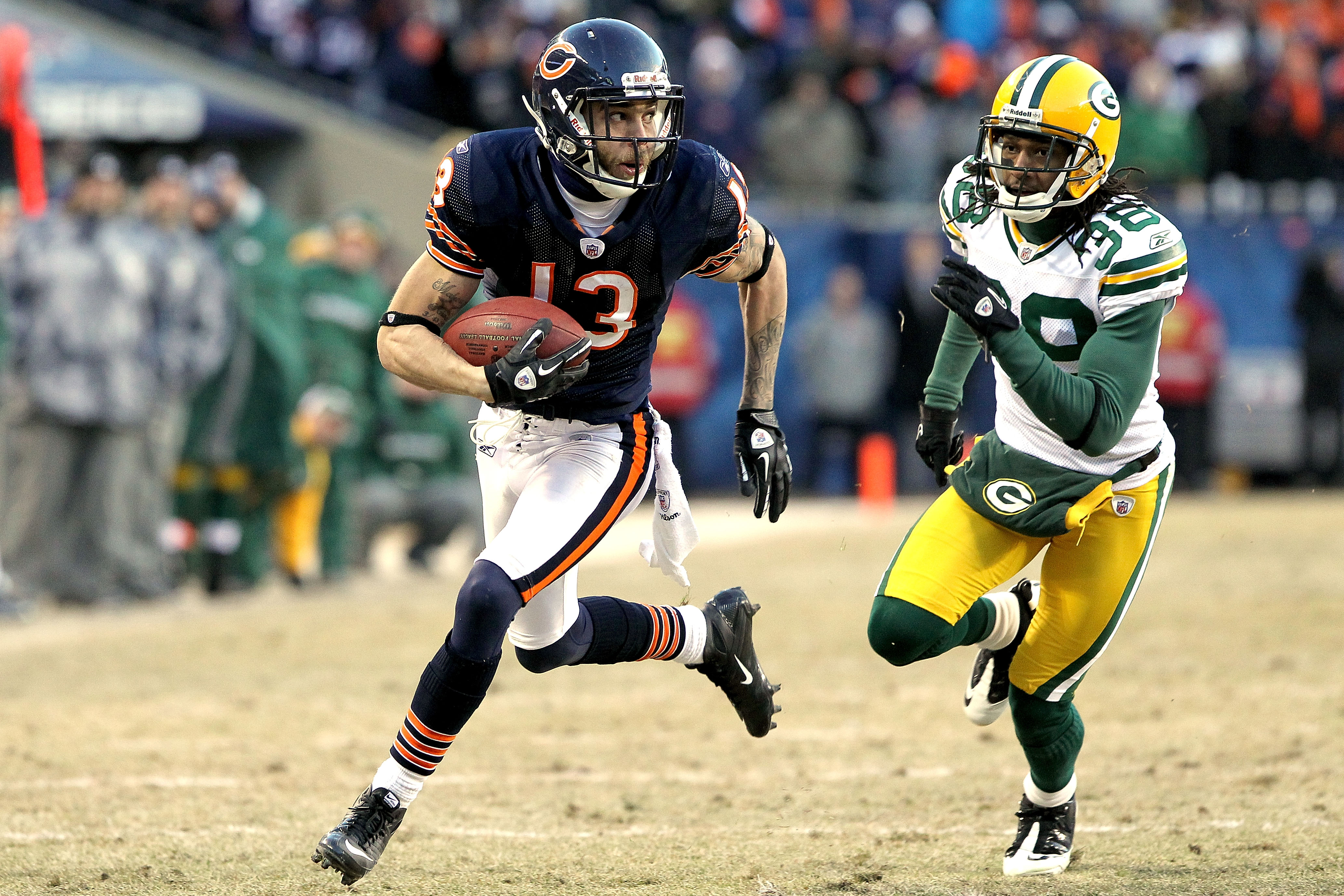 CHICAGO, IL - JANUARY 23:  Johnny Knox #13 of the Chicago Bears runs ahead of Tramon Williams #38 of the Green Bay Packers for a 32-yard gain in the fourth quarter in the NFC Championship Game at Soldier Field on January 23, 2011 in Chicago, Illinois.  (P