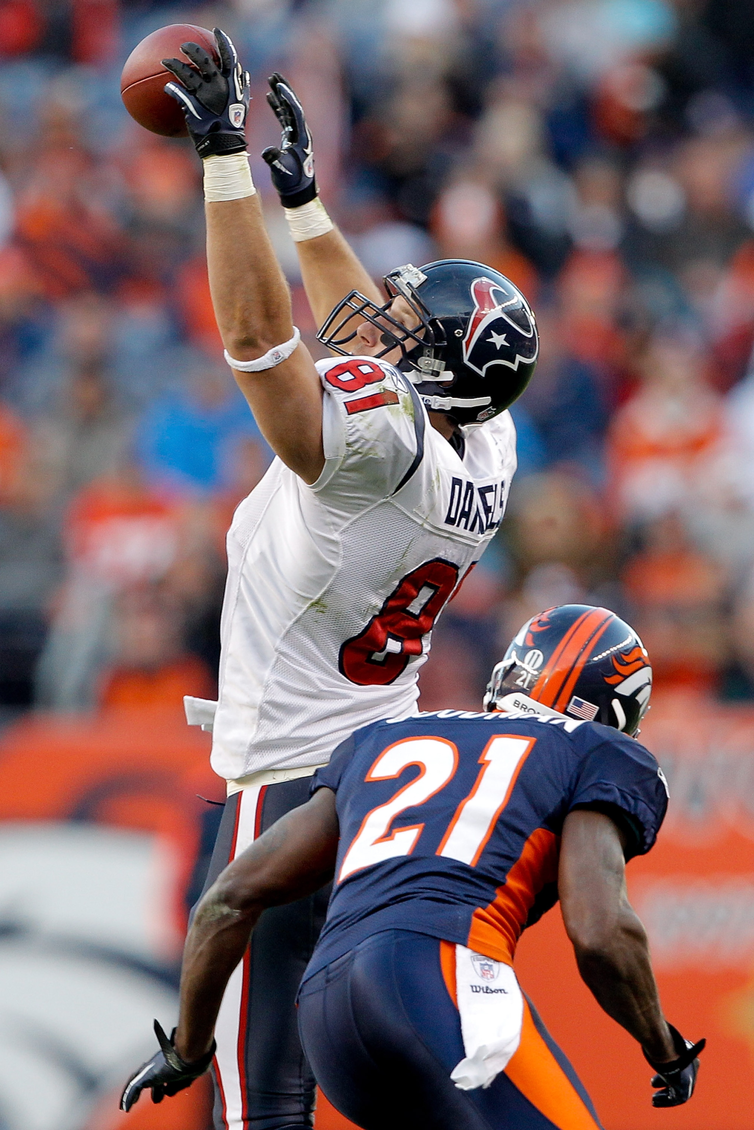 DENVER - DECEMBER 26:  Tight end Owen Daniels #81 of the Houston Texans makes a one-handed catch against cornerback Andre' Goodman #21 of the Denver Broncos during the third quarter at INVESCO Field at Mile High on December 26, 2010 in Denver, Colorado.