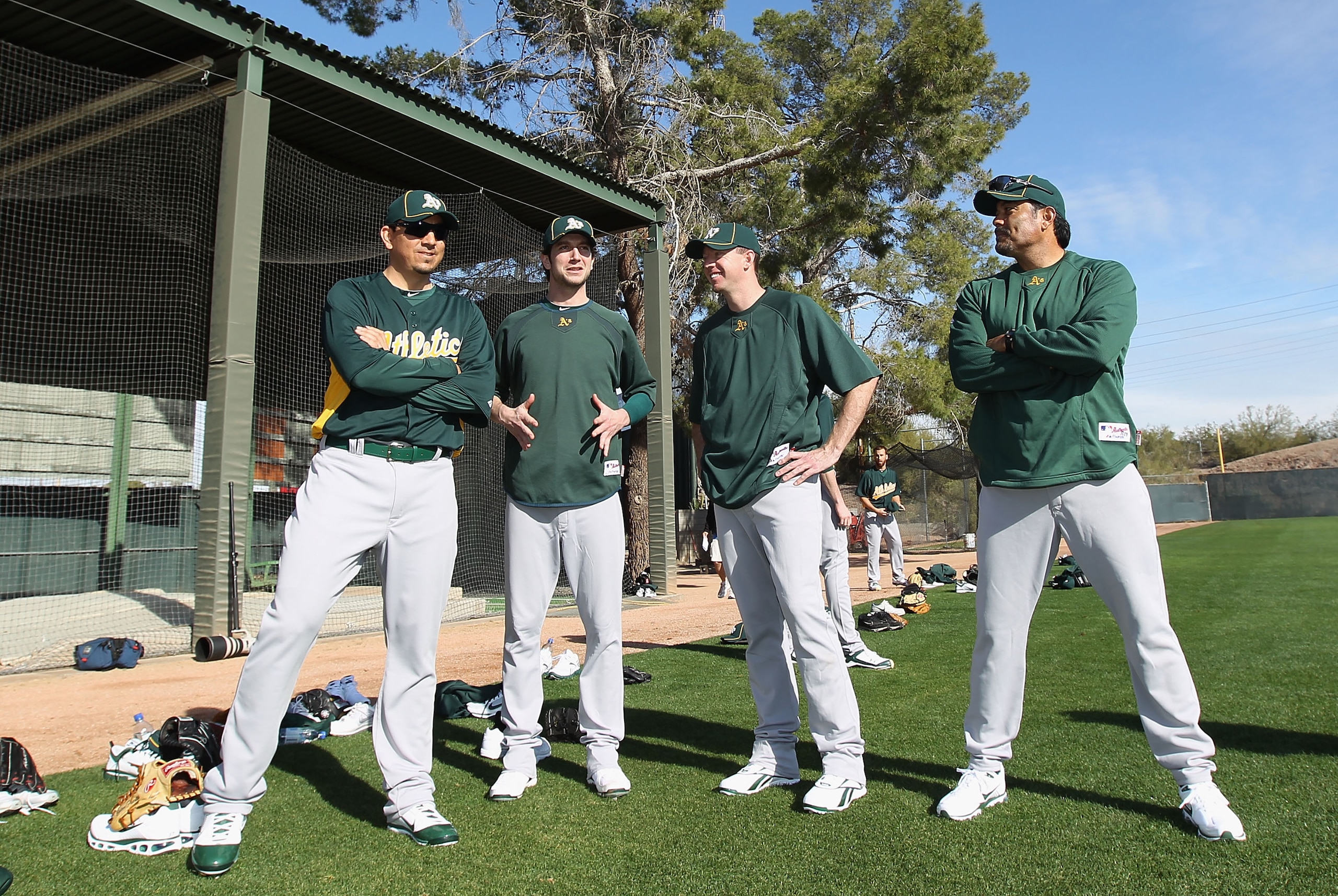 PHOENIX, AZ - FEBRUARY 16:  (L-R) Pitchers Brian Fuentes #57, Jerry Blevins #13, Brad Ziegler #31 and bullpen coach Rick Rodriguez of the Oakland Athletics talk during a MLB spring training practice at Phoenix Municipal Stadium on February 16, 2011 in Pho