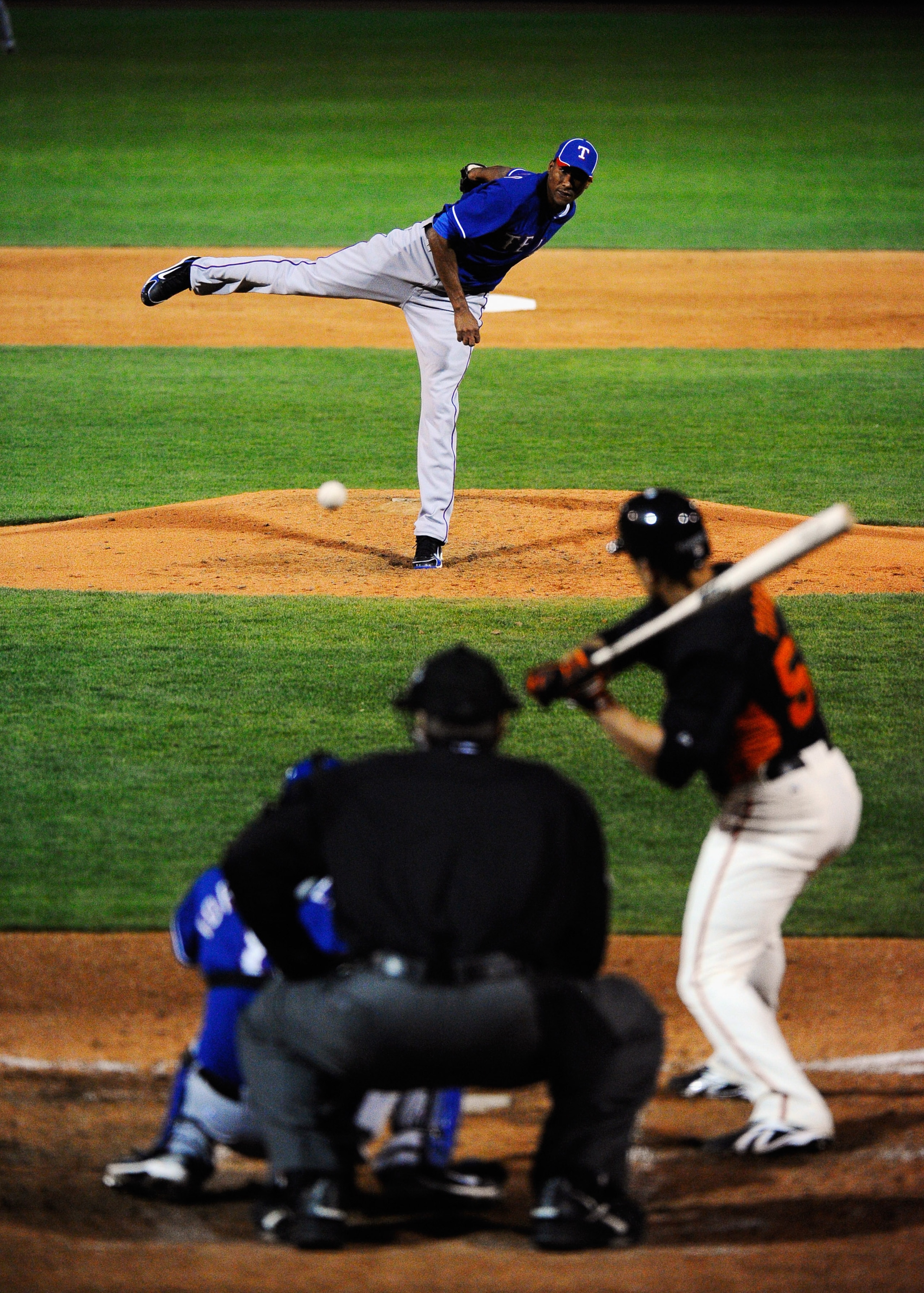 SCOTTSDALE, AZ - MARCH 07:  Pitcher Alexi Ogando #41 of the Texas Rangers throws a pitch against the San Francisco Giants in the first meeting between the two teams since the World Series during the spring training game at Scottsdale Stadium on March 7, 2