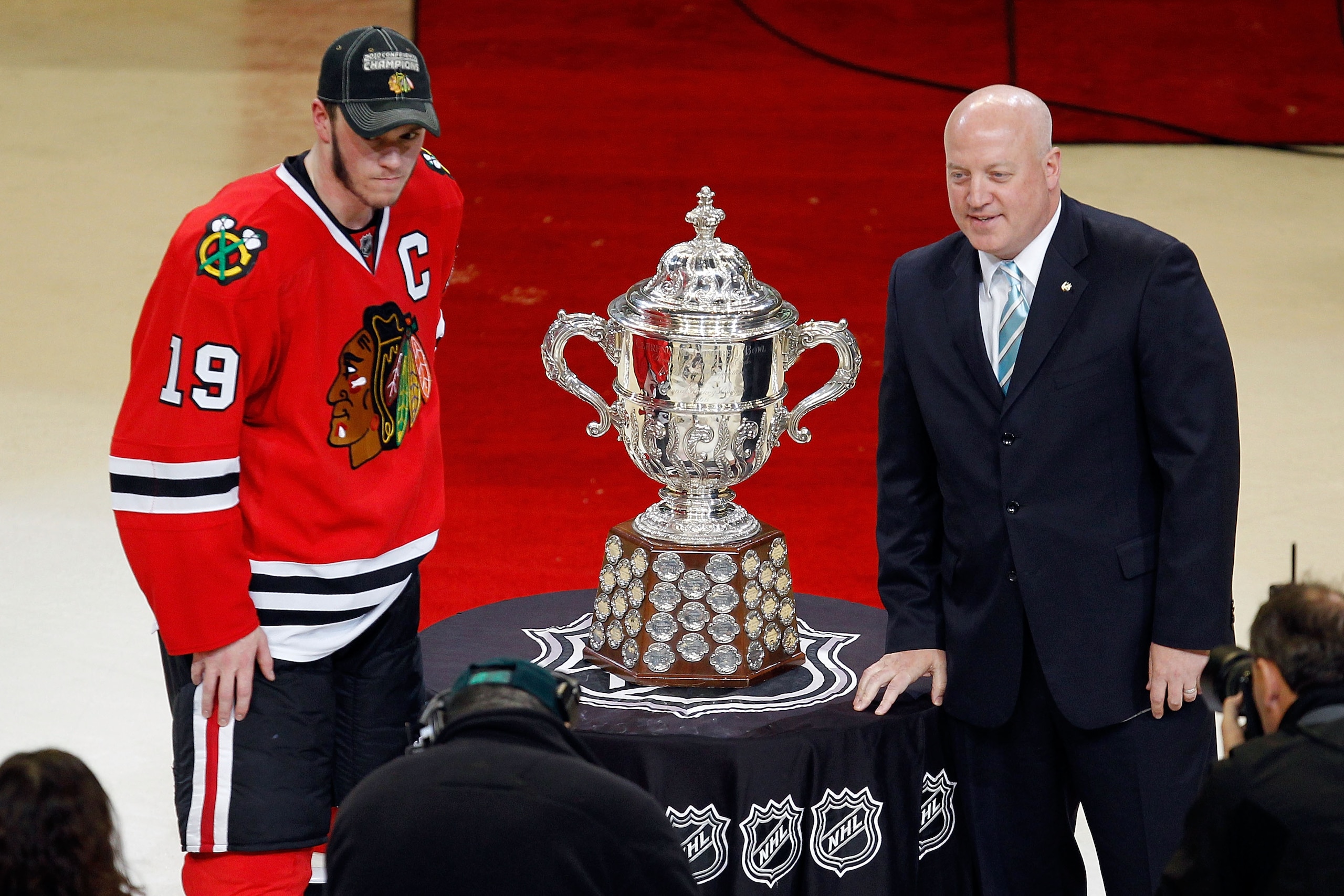 CHICAGO - MAY 23:  Jonathan Toews #19 of the Chicago Blackhawks poses with National Hockey League Deputy Commissioner Bill Daly as Toews receives the Campbell Trophy for winning the Western Conference after the Blackhawks 4-2 victory in Game Four of the W