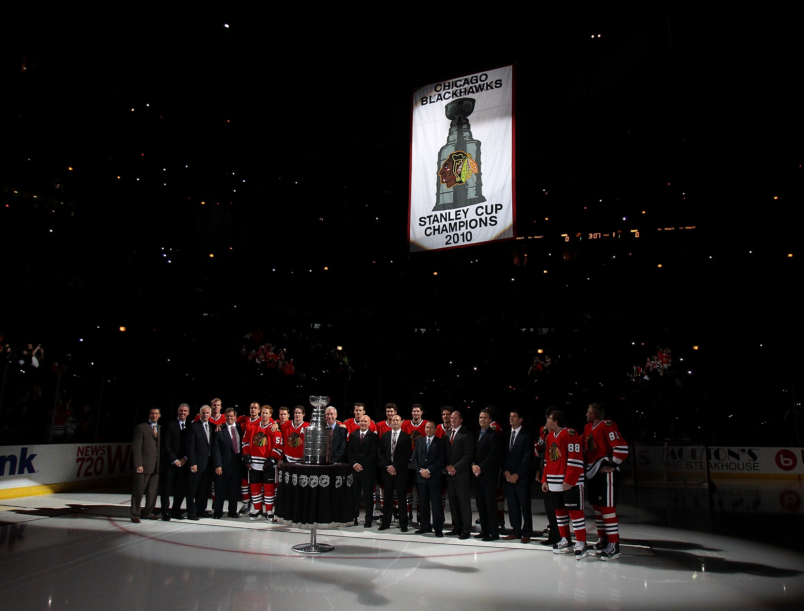 CHICAGO - OCTOBER 09: Members of the Chicago Blackhawks and their staff pose for a photo as the Stanley Cup Championship banner is raised during a ceremony before the Blackhawks season home opening game against the Detroit Red Wings at the United Center o