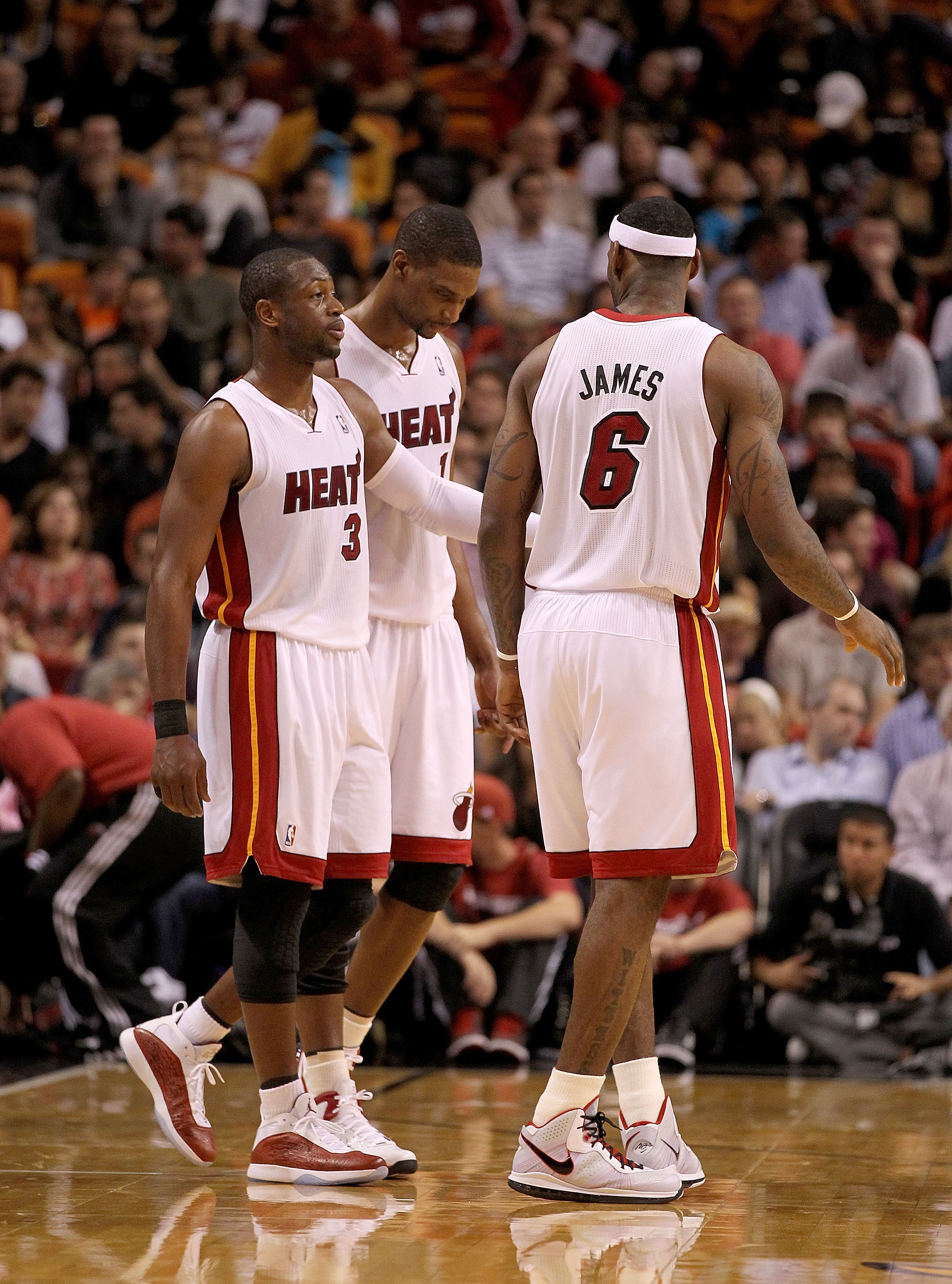 MIAMI, FL - FEBRUARY 25:  LeBron James #6, Dwyane Wade #3 and Chris Bosh #1 of the Miami Heat talk during a game against the Washington Wizards at American Airlines Arena on February 25, 2011 in Miami, Florida. NOTE TO USER: User expressly acknowledges an