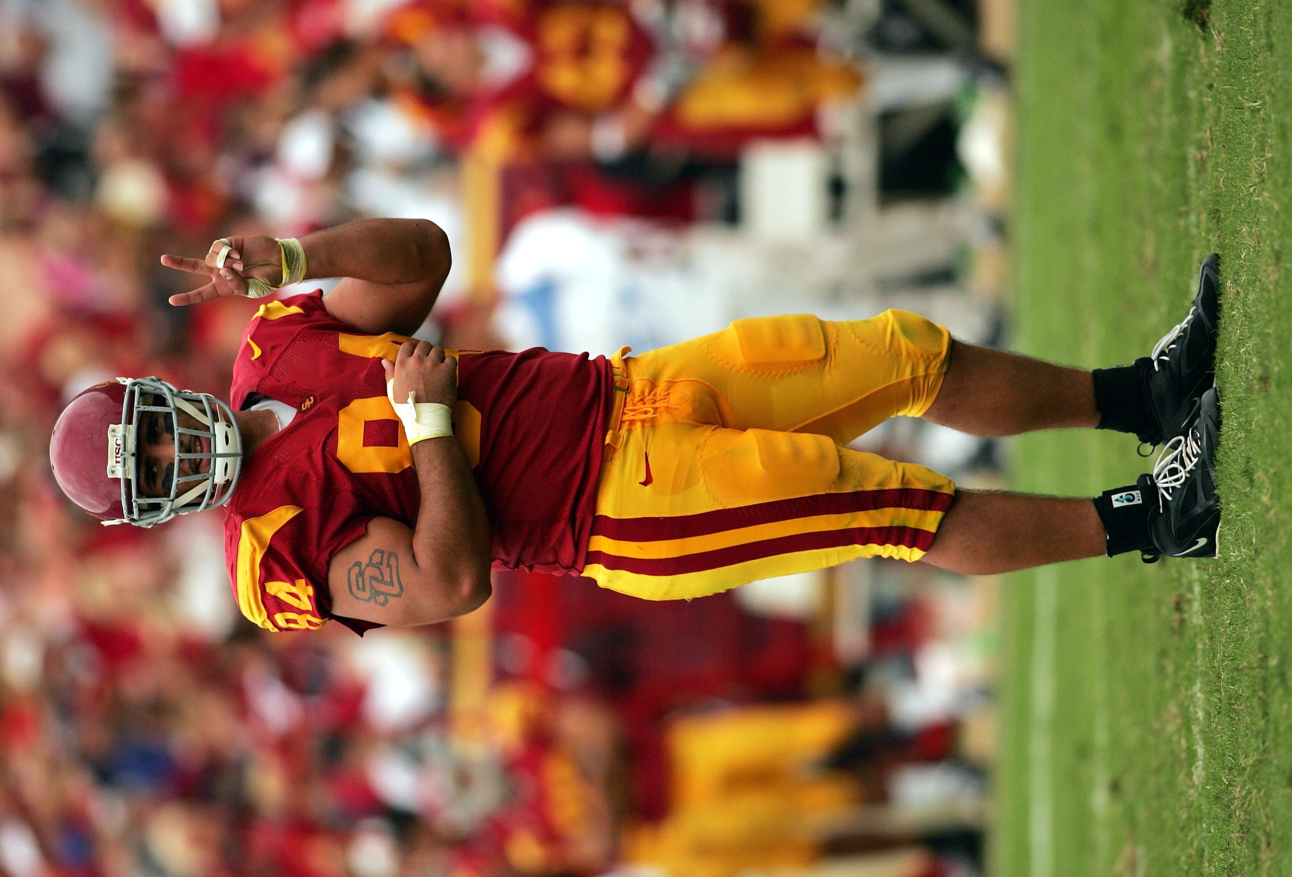 LOS ANGELES - OCTOBER 16: Defensive lineman Shaun Cody #84 of the USC Trojans flashes the victory sign toward the Arizona State Sun Devils sideline during a timeout in the second quarter on October 16, 2004 at the Los Angeles Coliseum in Los Angeles, Cal LOS ANGELES - OCTOBER 16: Defensive lineman Shaun Cody #84 of the USC Trojans flashes the victory sign toward the Arizona State Sun Devils sideline during a timeout in the second quarter on October 16, 2004 at the Los Angeles Coliseum in Los Angeles, Cal