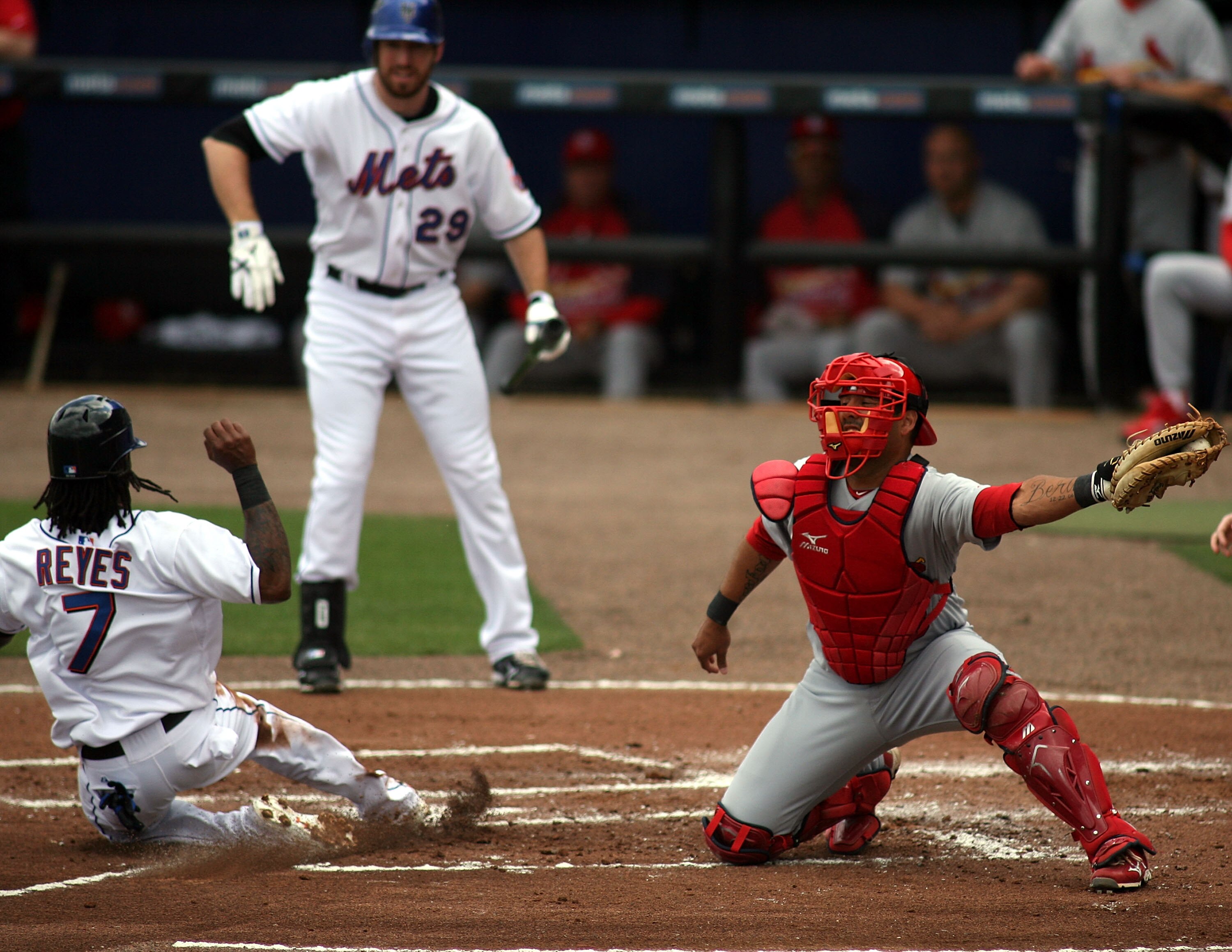 PORT ST. LUCIE, FL - MARCH 03:  Jose Reyes #7 of the New York Mets slides safely into home as catcher Gerald Laird #13  of the St. Louis Cardinals stealing second base at Digital Domain Park on March 3, 2011 in Port St. Lucie, Florida.  (Photo by Marc Ser