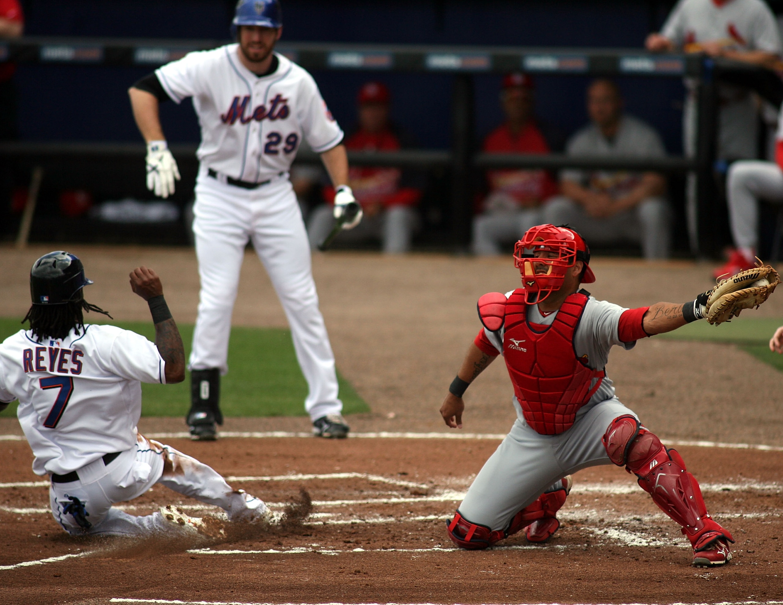 PORT ST. LUCIE, FL - MARCH 03:  Jose Reyes #7 of the New York Mets slides safely into home as catcher Gerald Laird #13  of the St. Louis Cardinals stealing second base at Digital Domain Park on March 3, 2011 in Port St. Lucie, Florida.  (Photo by Marc Ser