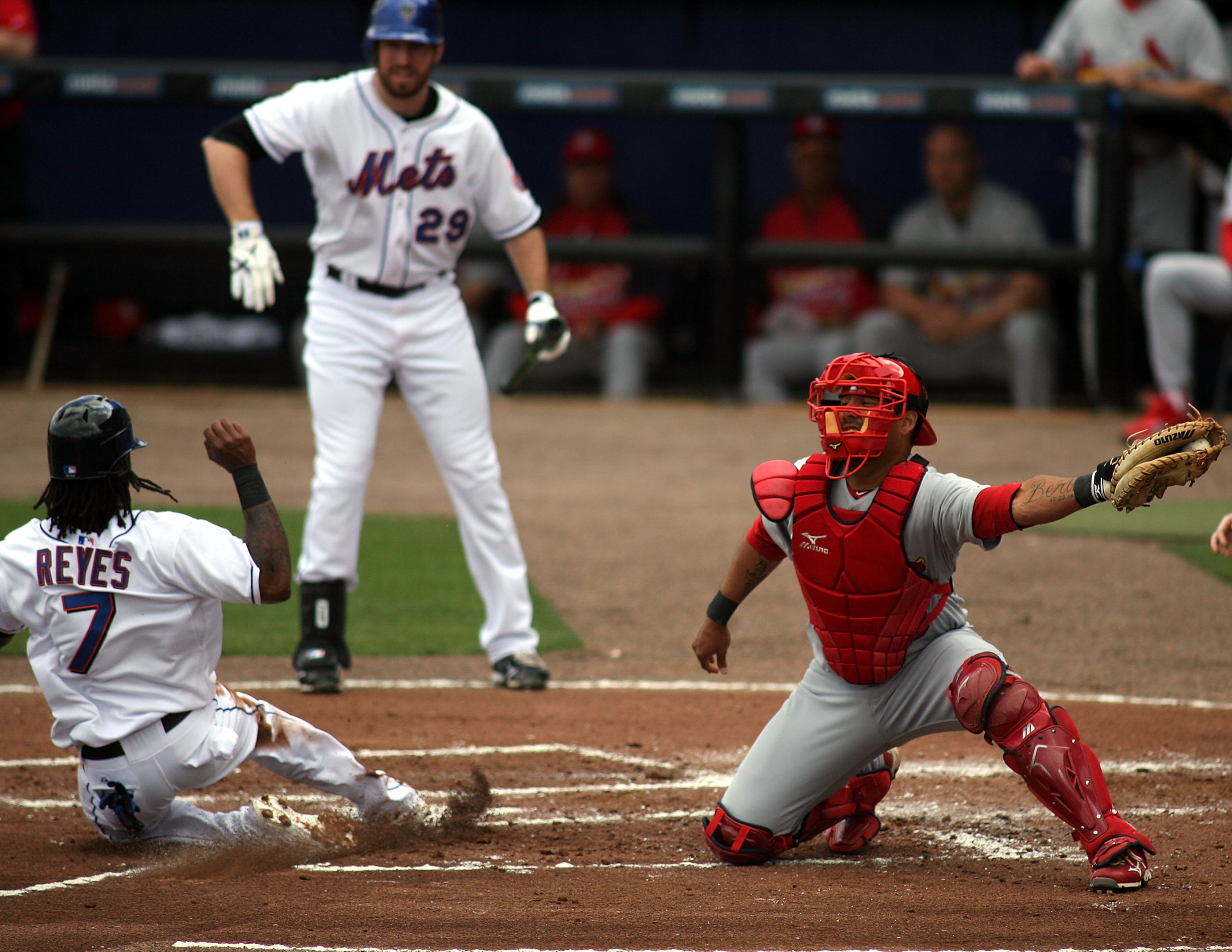 PORT ST. LUCIE, FL - MARCH 03:  Jose Reyes #7 of the New York Mets slides safely into home as catcher Gerald Laird #13  of the St. Louis Cardinals stealing second base at Digital Domain Park on March 3, 2011 in Port St. Lucie, Florida.  (Photo by Marc Ser