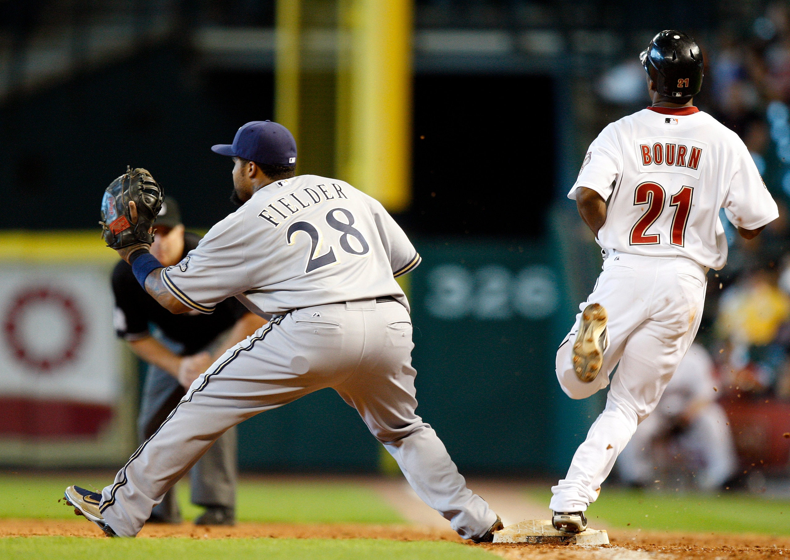 HOUSTON - SEPTEMBER 15:  Michael Bourn #21 of the Houston Astros beats the the throw to first base as Prince Fielder #28of the Milwaukee Brewers awaits the throw at Minute Maid Park on September 15, 2010 in Houston, Texas.  (Photo by Bob Levey/Getty Image