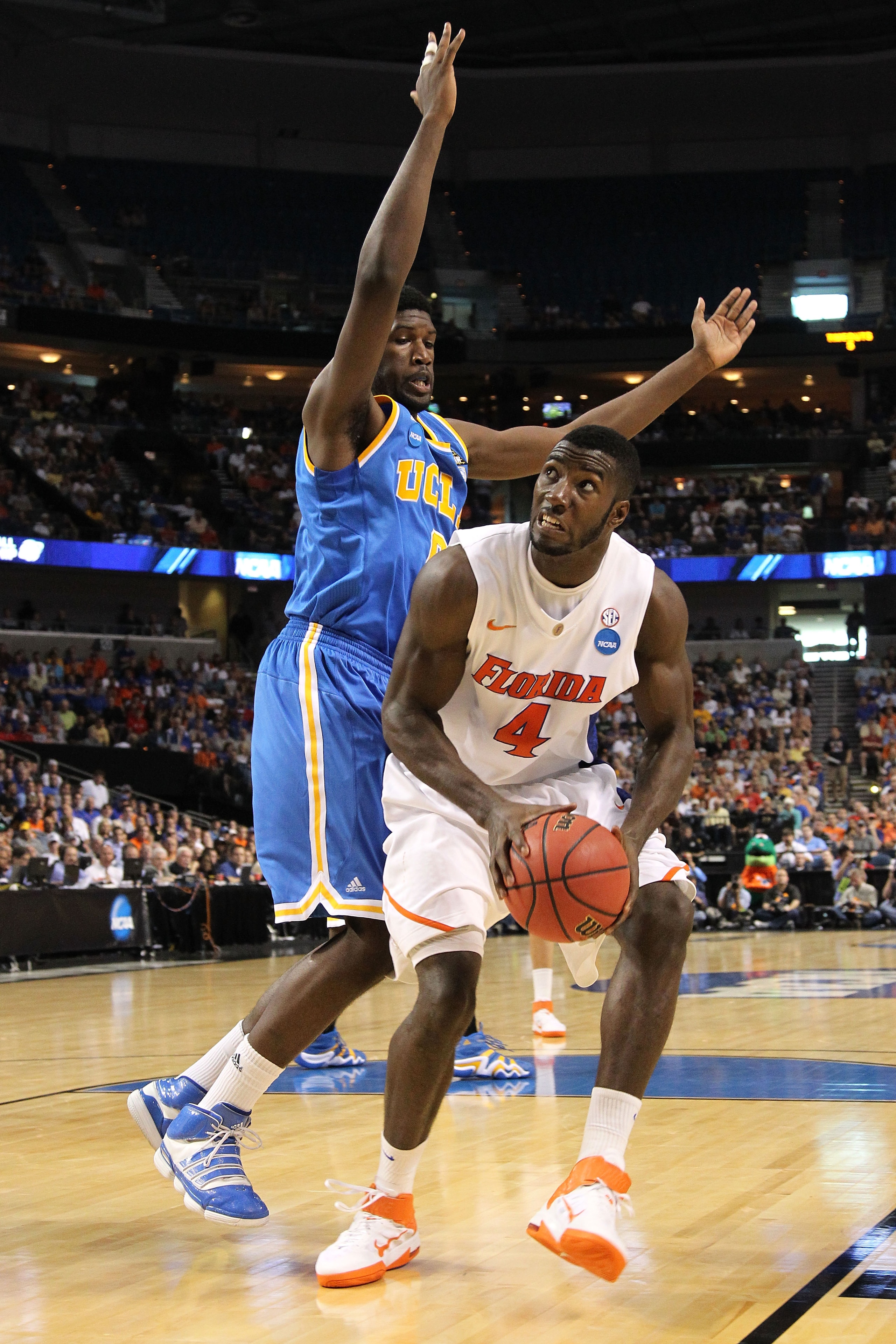 TAMPA, FL - MARCH 19:  Patric Young #4 of the Florida Gators drives against Anthony Stover #0 of the UCLA Bruins during the third round of the 2011 NCAA men's basketball tournament at St. Pete Times Forum on March 19, 2011 in Tampa, Florida.  (Photo by Mi