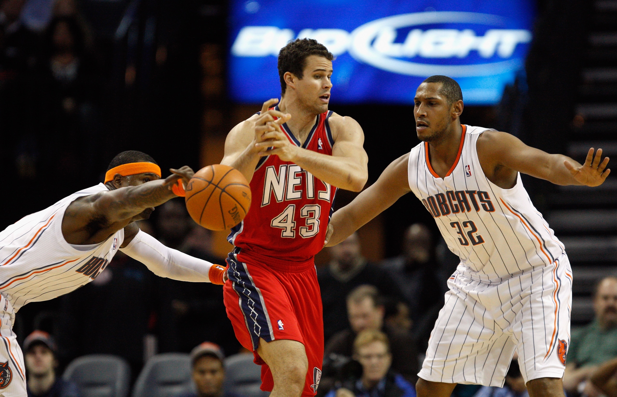 CHARLOTTE, NC - FEBRUARY 11:  Kris Humphries #43 of the New Jersey Nets has the ball knocked loose by Stephen Jackson #1 of the Charlotte Bobcats as teammate Boris Diaw #32 watches on during their game at Time Warner Cable Arena on February 11, 2011 in Ch