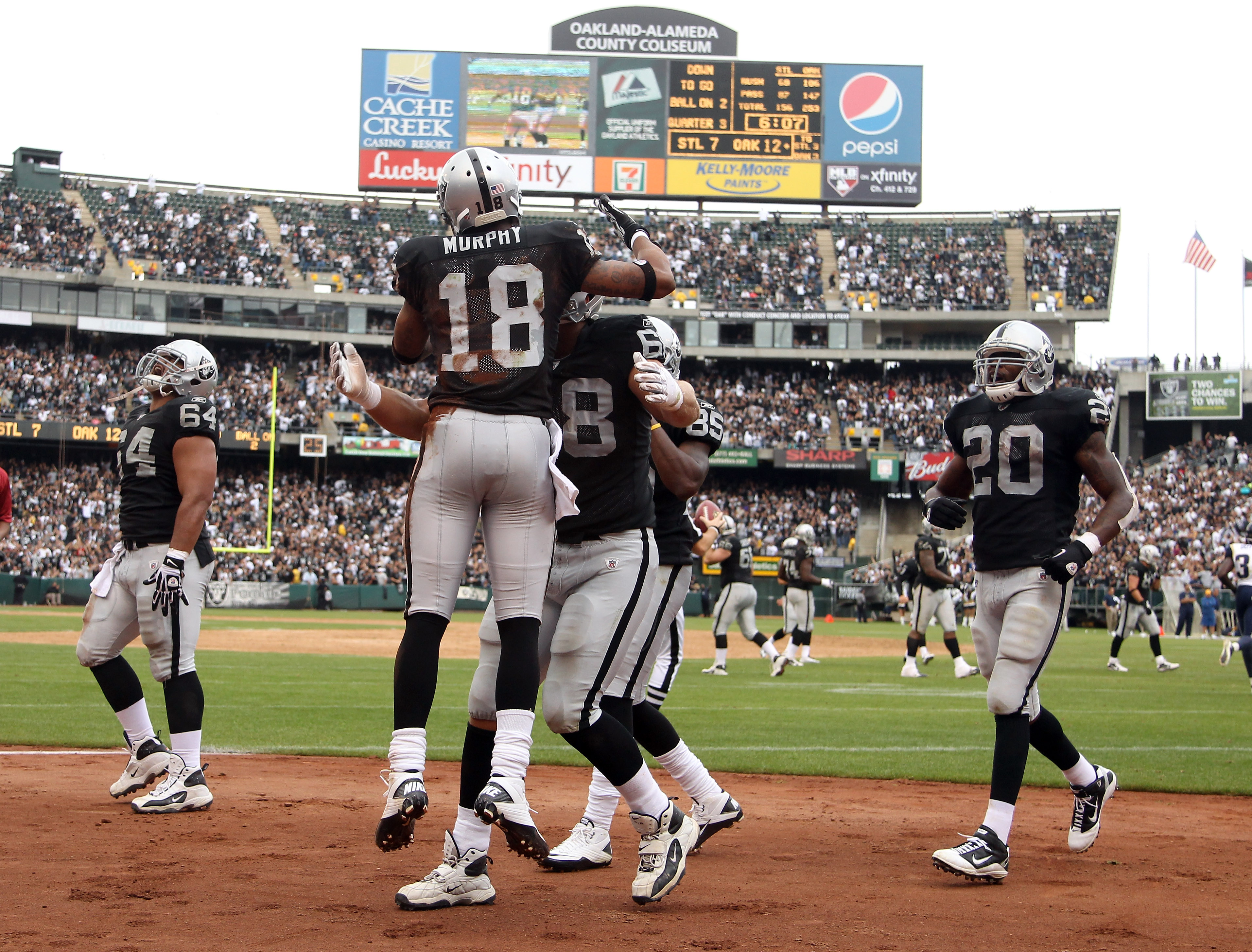 OAKLAND, CA - SEPTEMBER 19:  Louis Murphy #18 of the Oakland Raiders is congratulated by teammates after he scored a touchdown during their game against the St. Louis Rams at the Oakland-Alameda County Coliseum on September 19, 2010 in Oakland, California