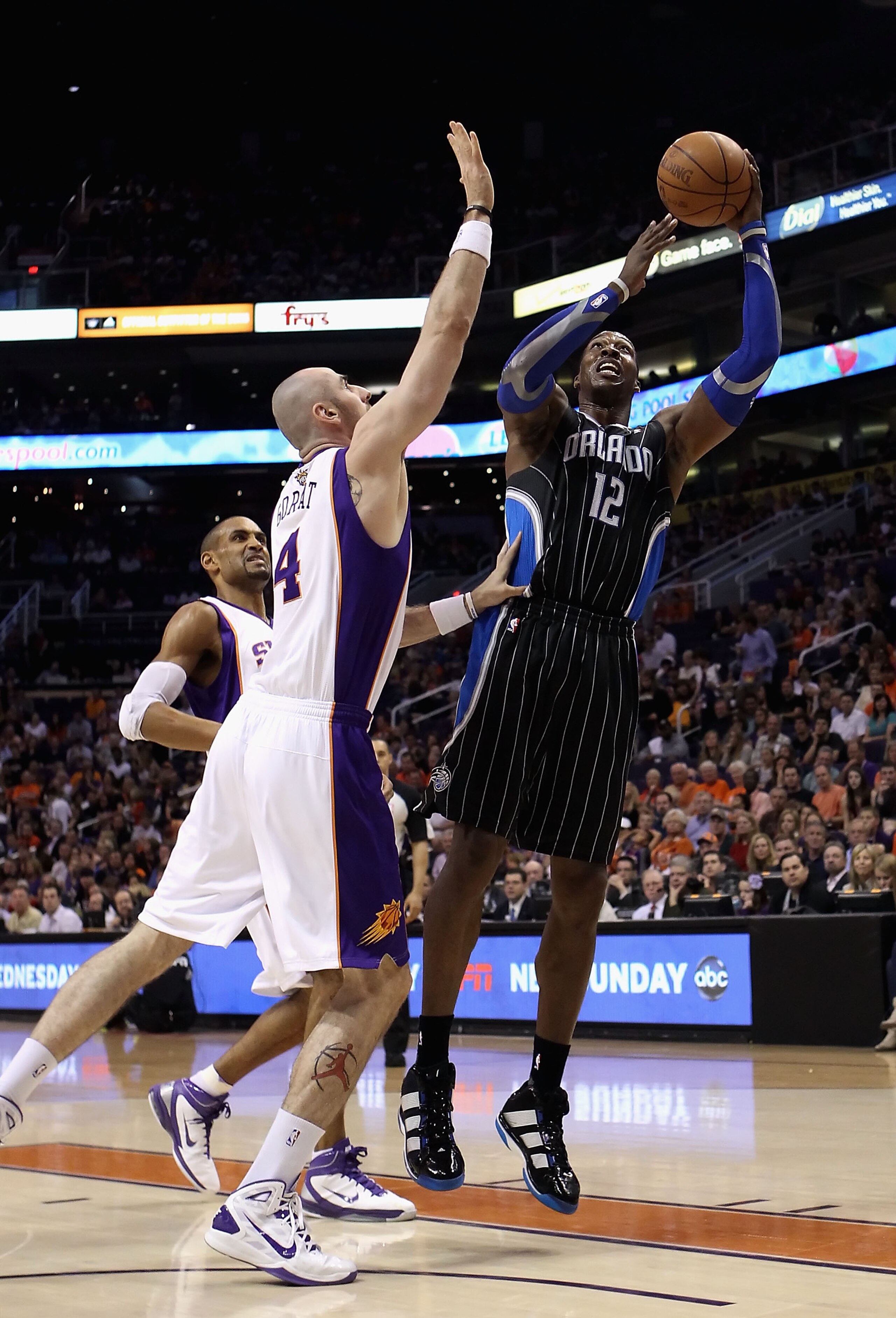 PHOENIX, AZ - MARCH 13:  Dwight Howard #12 of the Orlando Magic puts up a shot during the NBA game against the Phoenix Suns at US Airways Center on March 13, 2011 in Phoenix, Arizona. The Magic defeated the Suns 111-88. NOTE TO USER: User expressly acknow