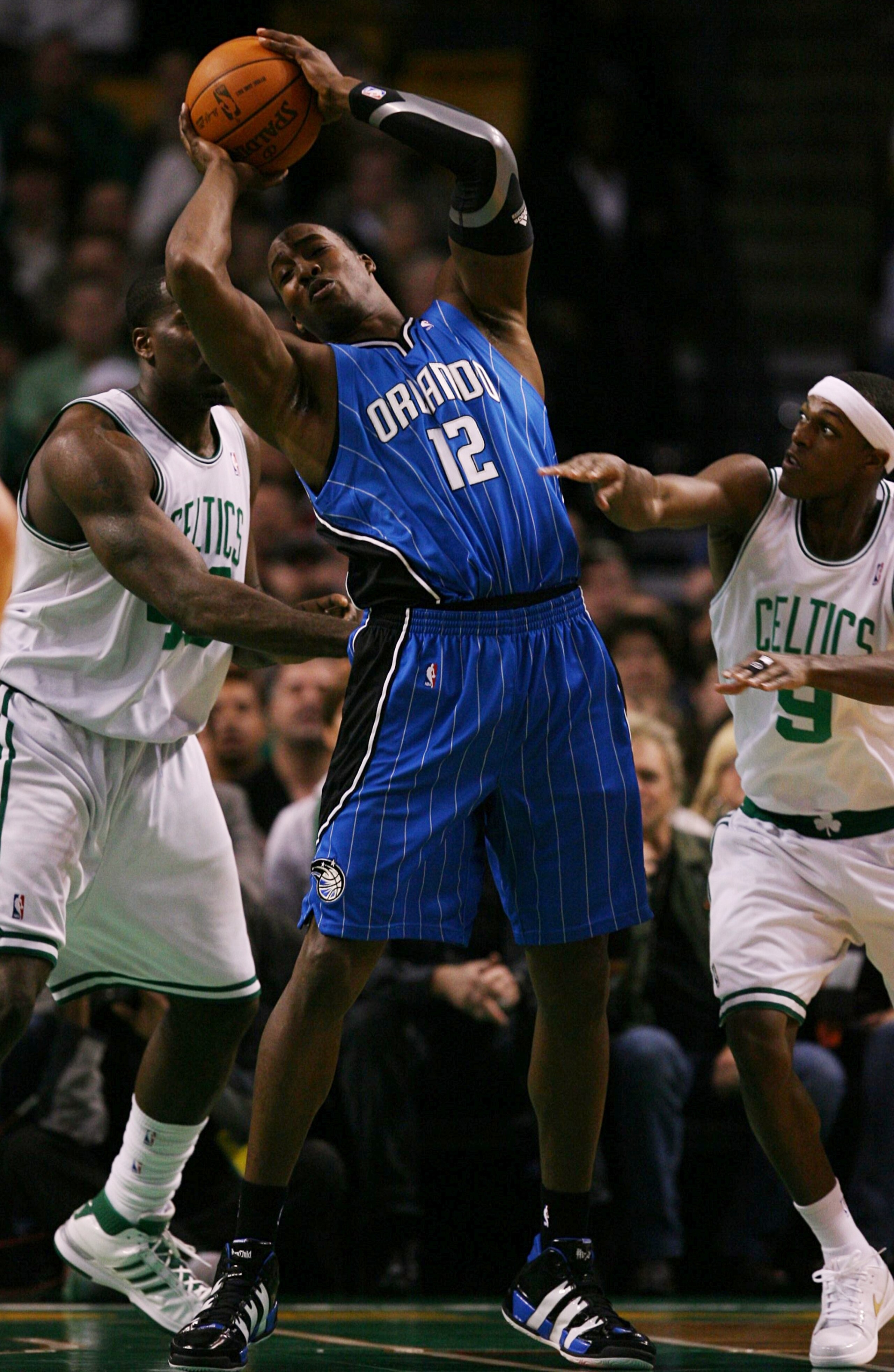 BOSTON - NOVEMBER 20: Dwight Howard #12 of the Orlando Magic draws a double team by Kendrick Perkins #43 and Rajon Rondo #9 of the Boston Celtics during the game on November 20, 2009 at the TD Garden in Boston, Massachusetts. NOTE TO USER: User expressly